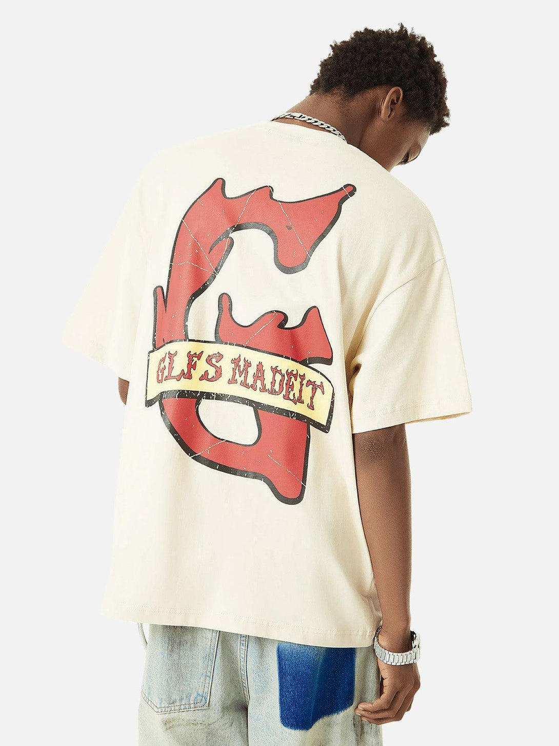 Back view of a graffiti-style T-shirt by TALISHKO, featuring bold red and black design.