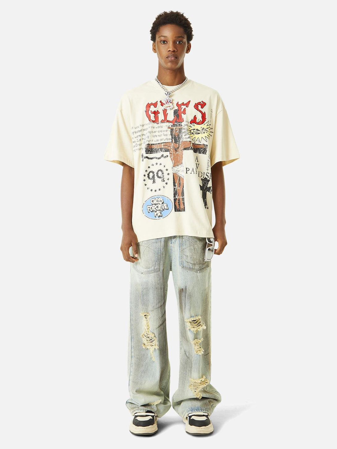 Model wearing a TALISHKO graffiti T-shirt with distressed jeans, exuding a casual urban vibe.