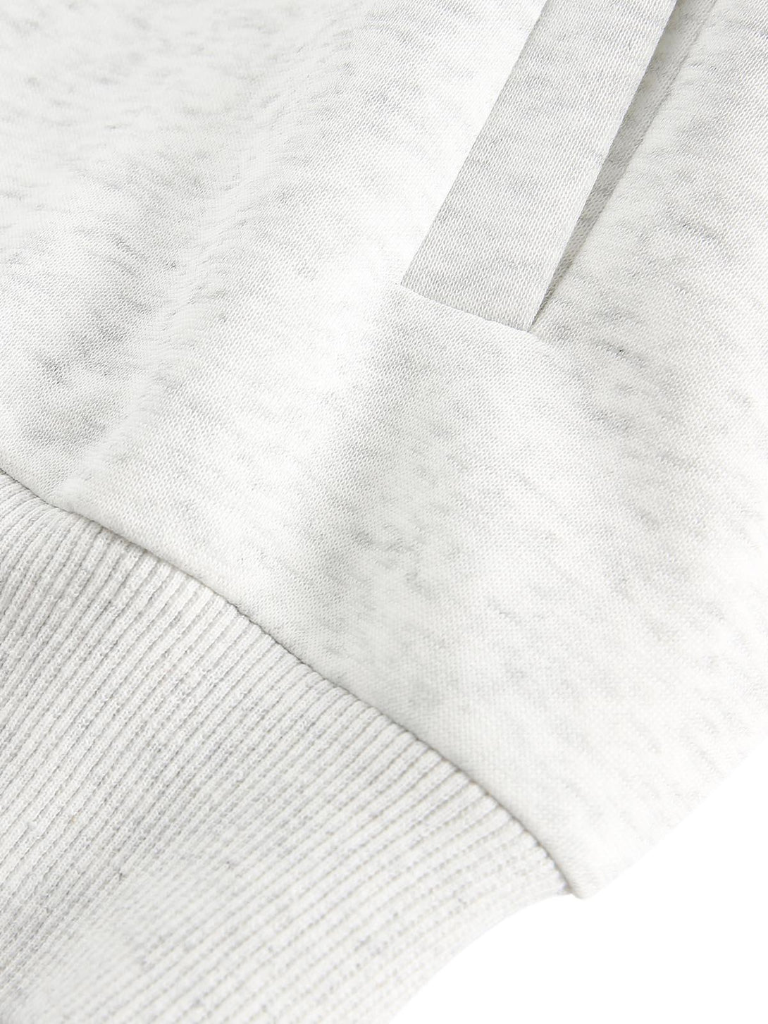 A detailed view of stitching and fabric texture on a TALISHKO cardigan, showcasing craftsmanship.