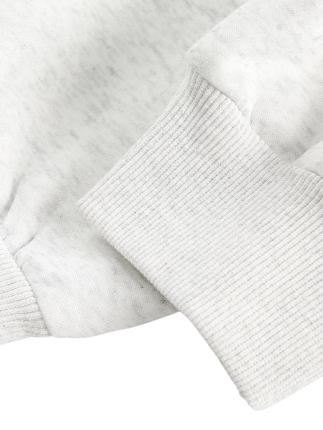 A tight crop highlighting the ribbed cuff detail on a TALISHKO cardigan, showcasing texture.