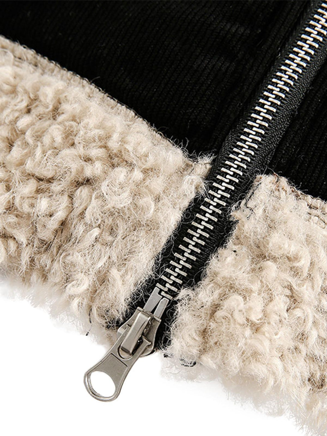 Detailed fabric and stitching of TALISHKO sherpa-lined jacket with a fur collar and zip detail.