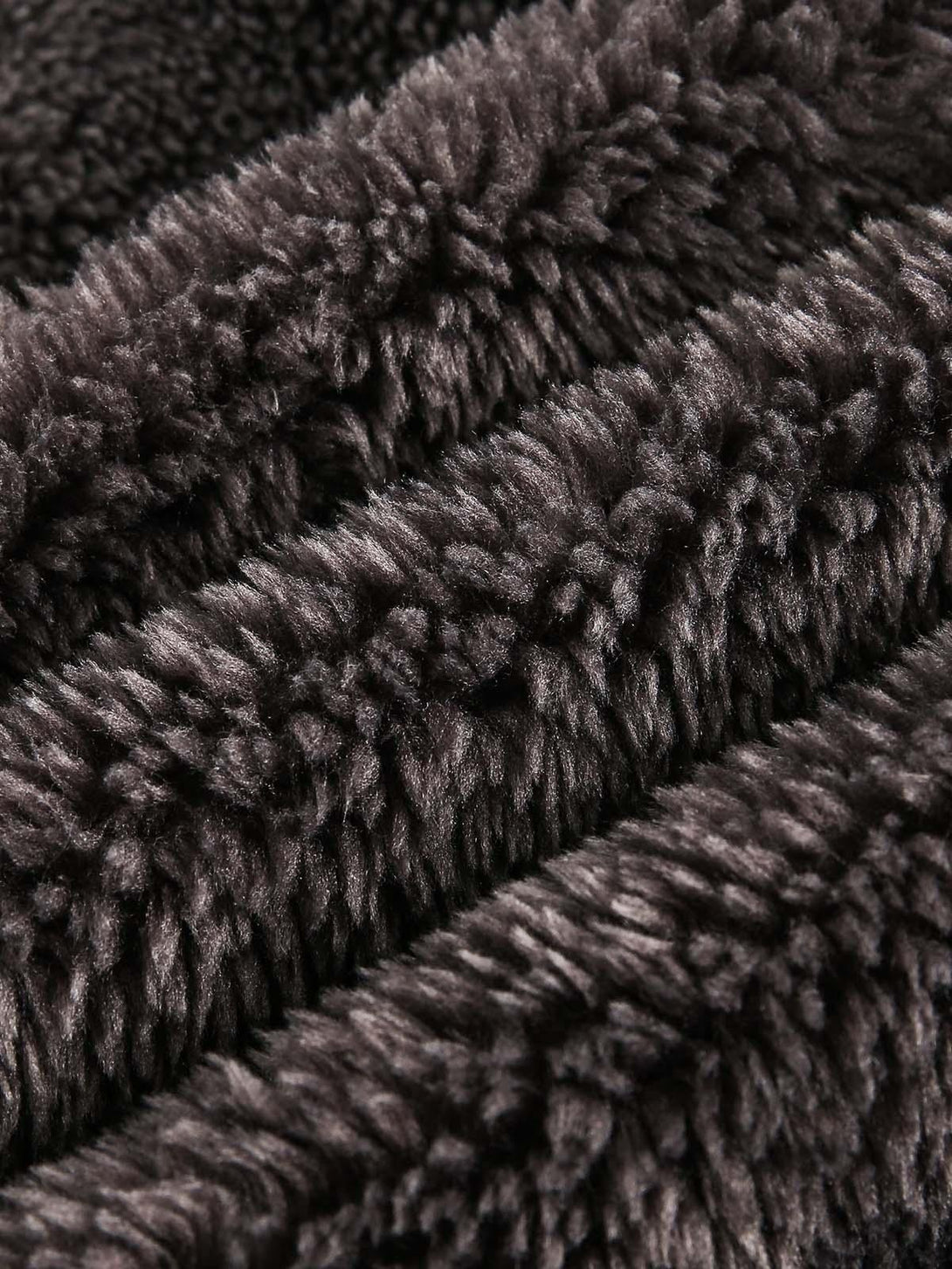Plush texture of TALISHKO's sherpa jacket, perfect for adding cozy warmth to any look.