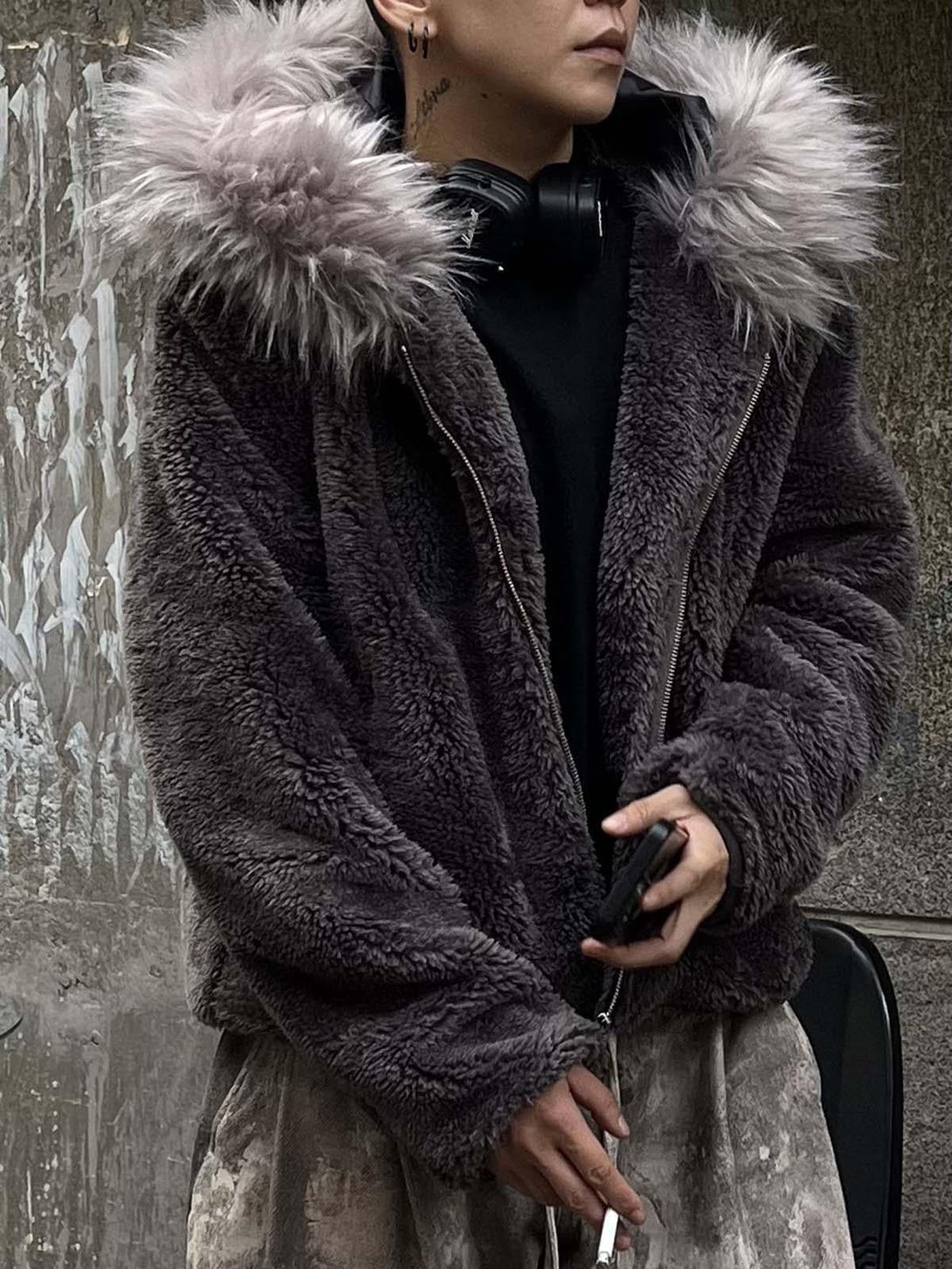 Model wearing TALISHKO's plush sherpa jacket with a fluffy faux fur hood, exuding urban style.