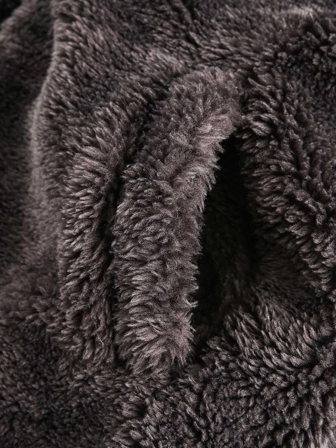 Intricate look at the plush texture of TALISHKO's sherpa jacket, highlighting cozy warmth.