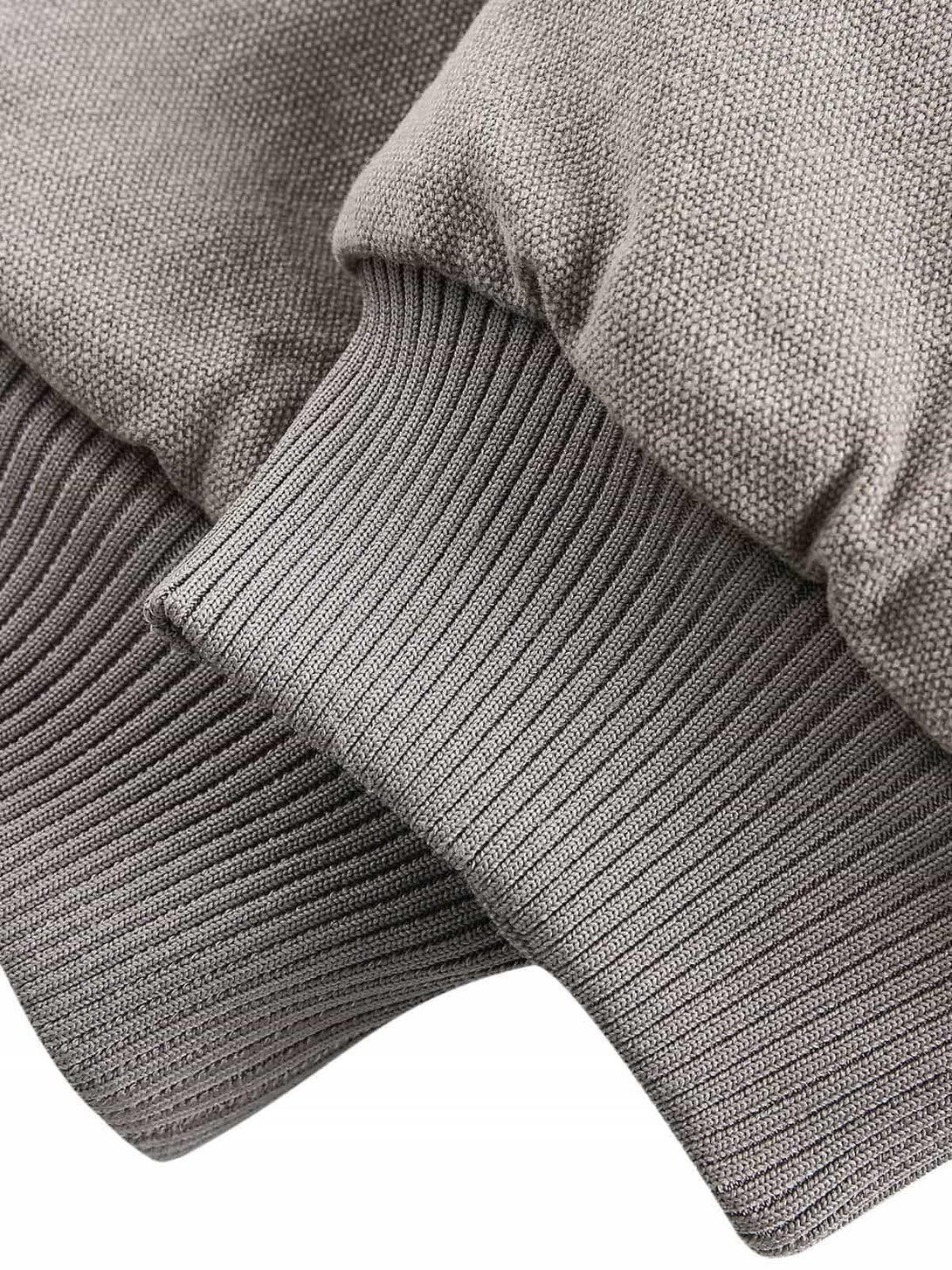 "Detailed fabric and stitching of TALISHKO's quilted jacket, showcasing the ribbed cuff design."