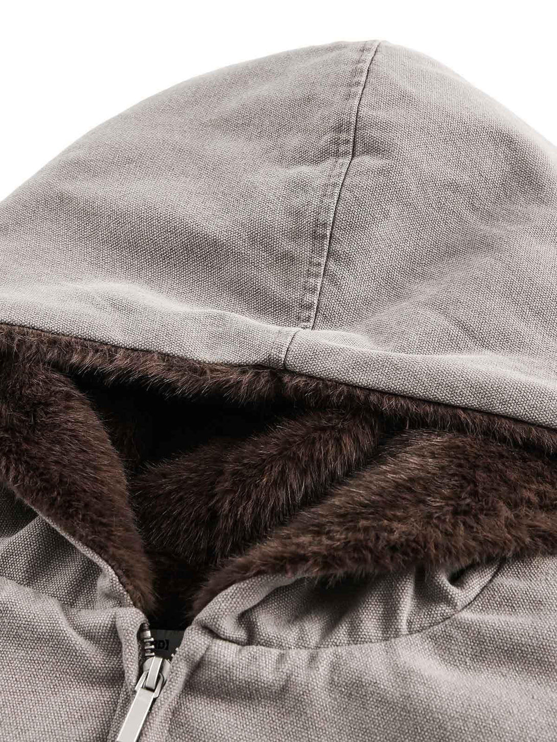 A close-up of TALISHKO's fur-lined hood on a quilted jacket, highlighting cozy texture.