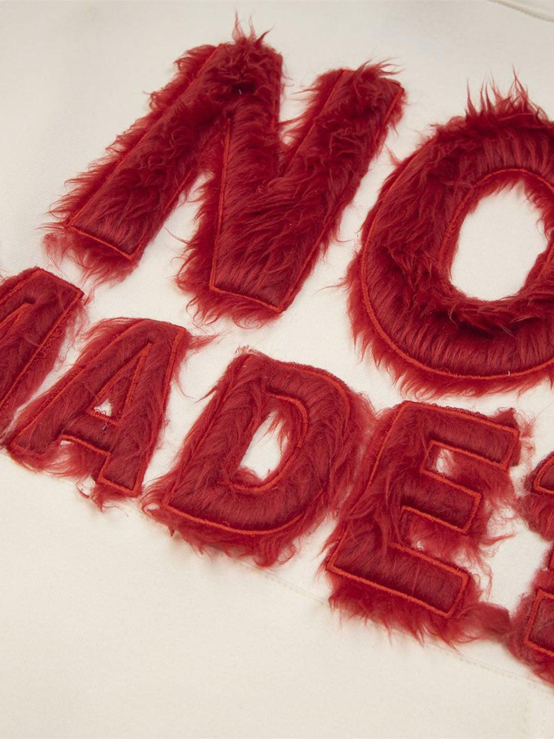 Focusing on the intricate fur patchwork and embroidery detail on a hoodie by TALISHKO.