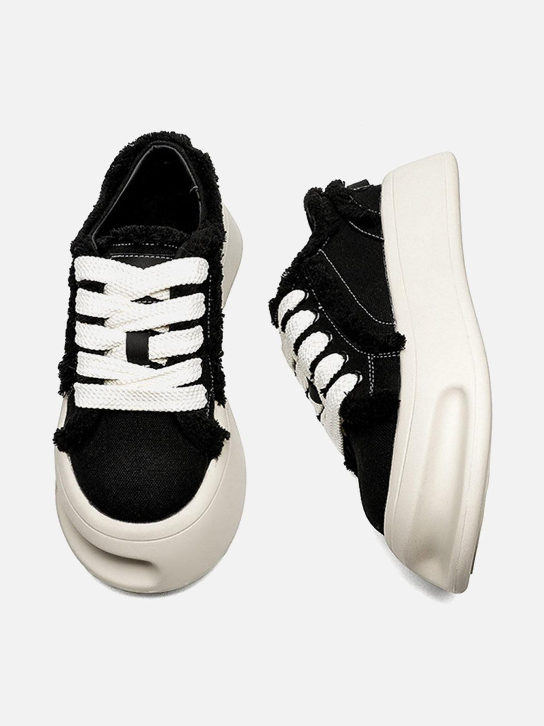 TALISHKO's unique black chunk shoes with fuzzy trim and bold white laces, viewed from above.