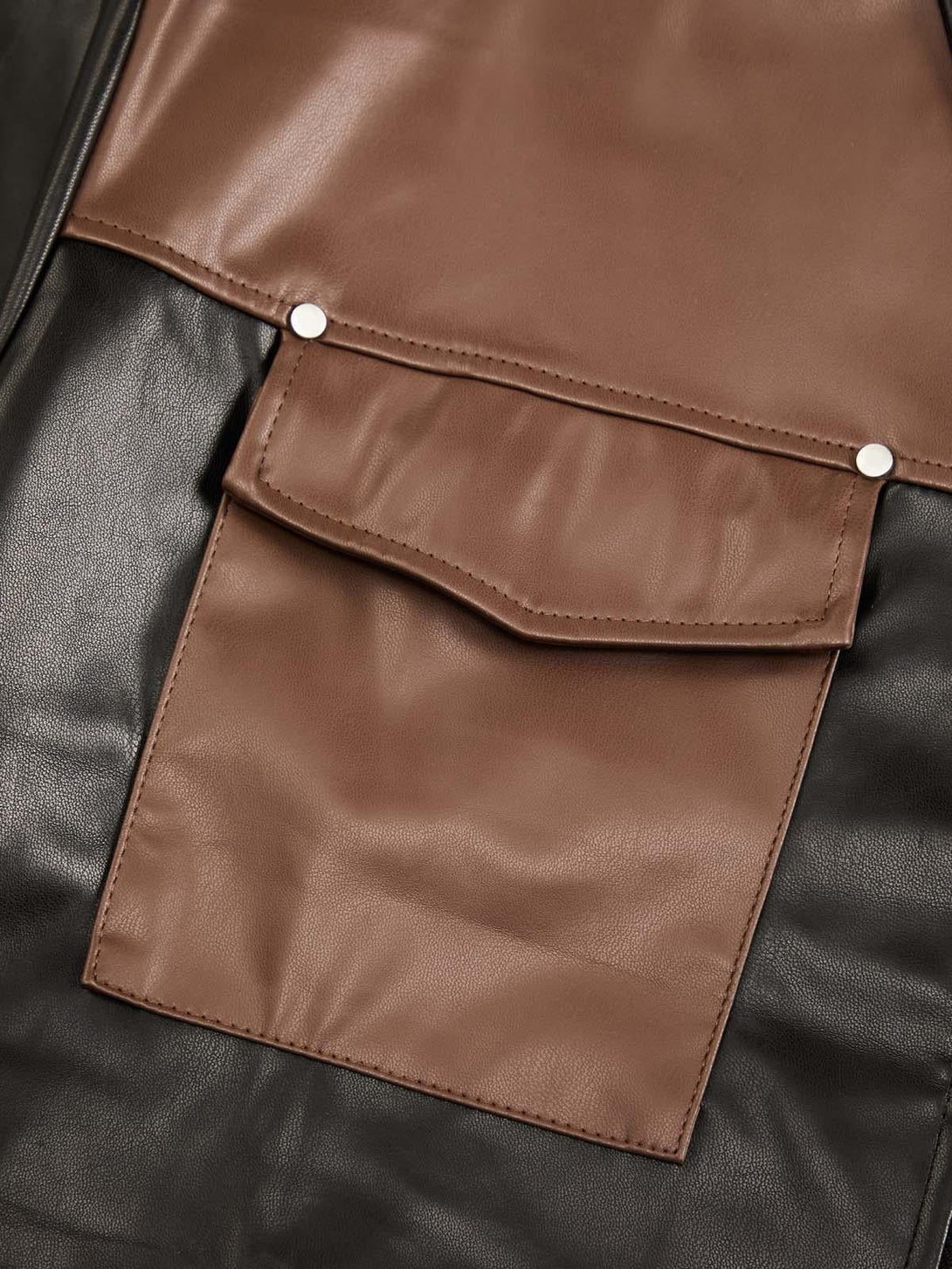 Intricate look at TALISHKO's patchwork leather shirt pocket, highlighting contrast textures.