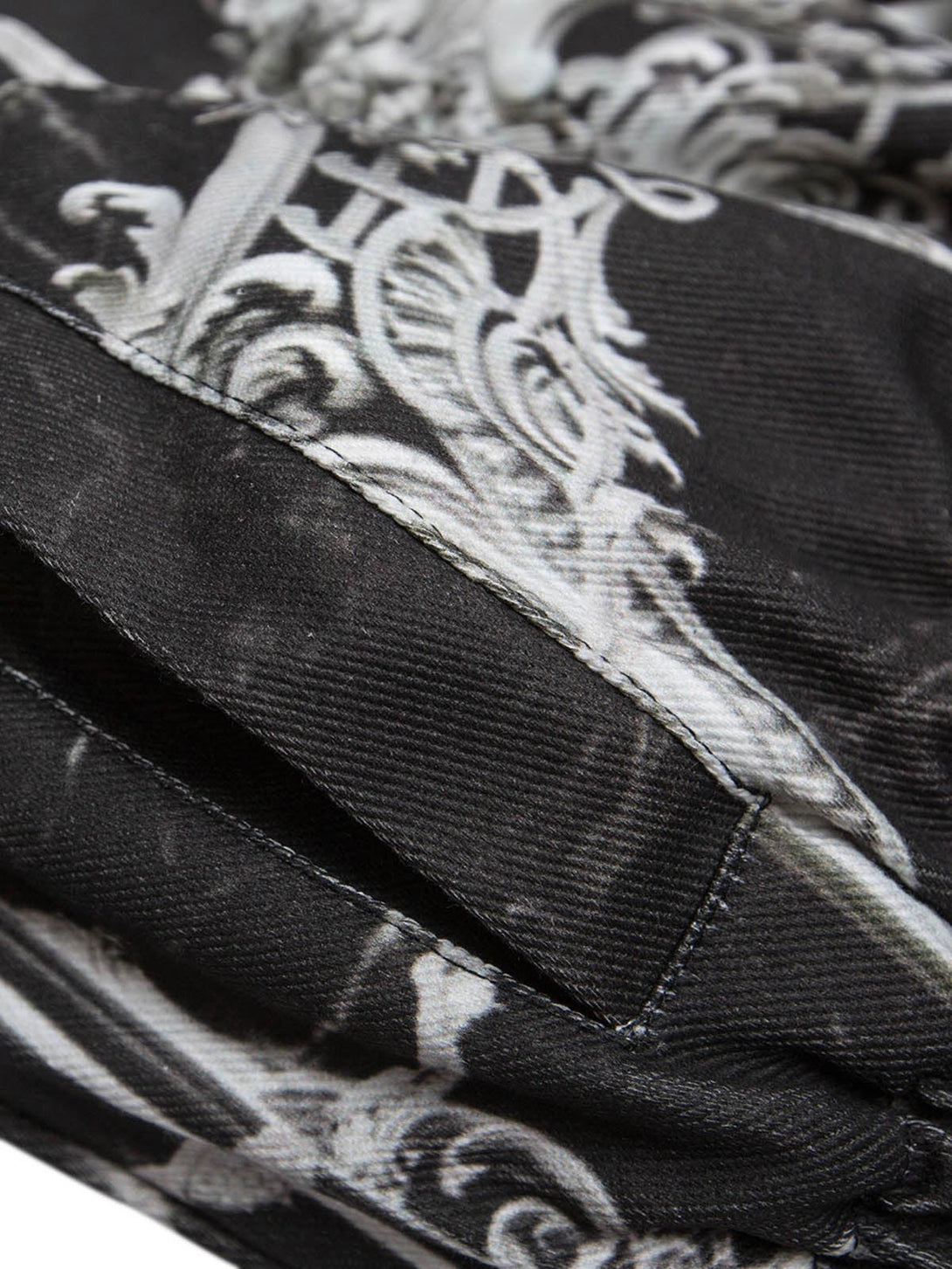 Intricate fabric detail of a TALISHKO gem-printed bomber jacket highlighting its unique pattern.