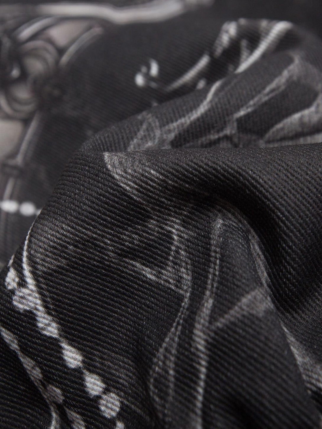 Texture and pattern showcased in TALISHKO's gem-printed quilted bomber jacket fabric.