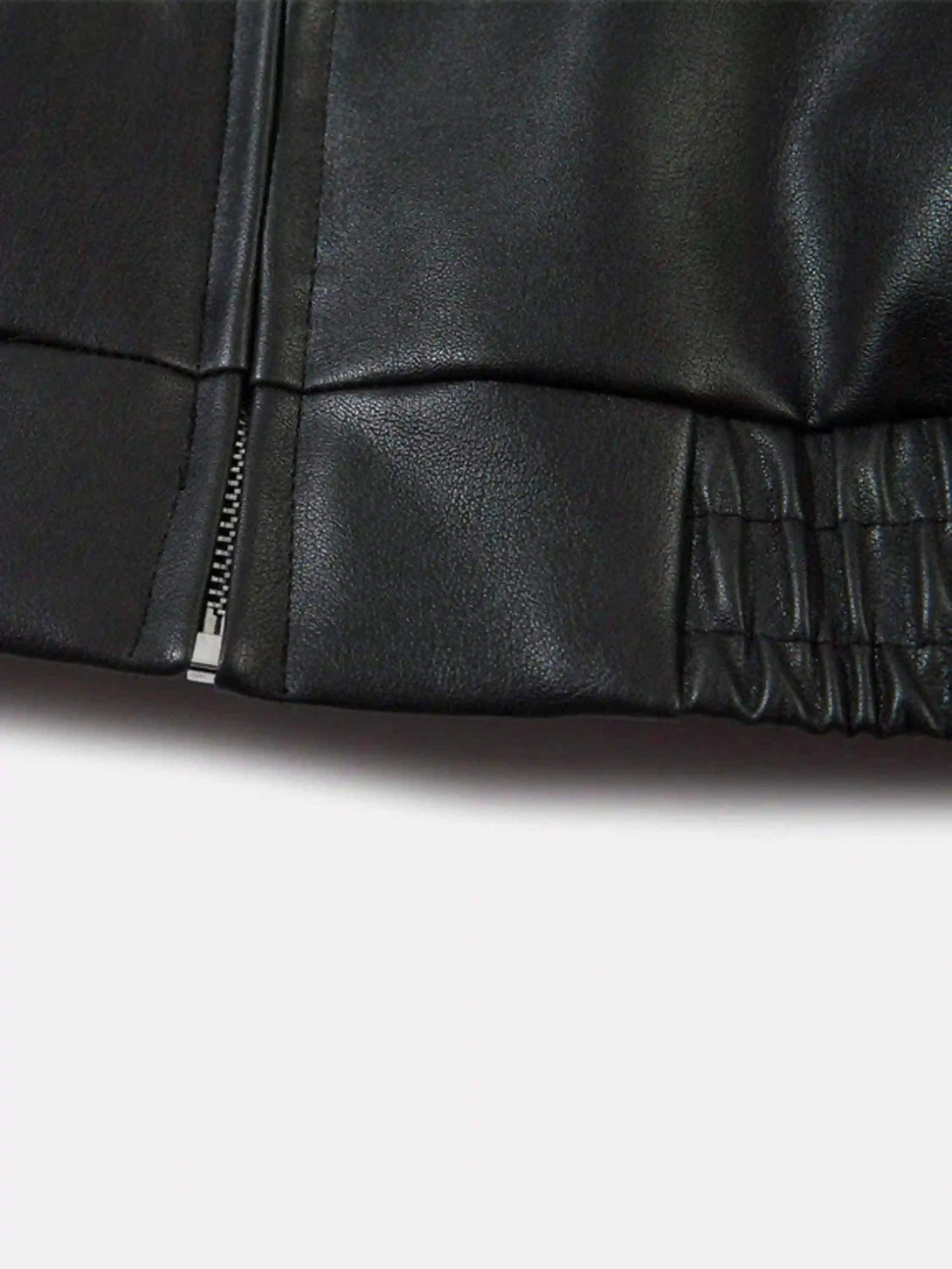 Intricate look at TALISHKO's black jacket, highlighting the sleek zipper and elastic detail.