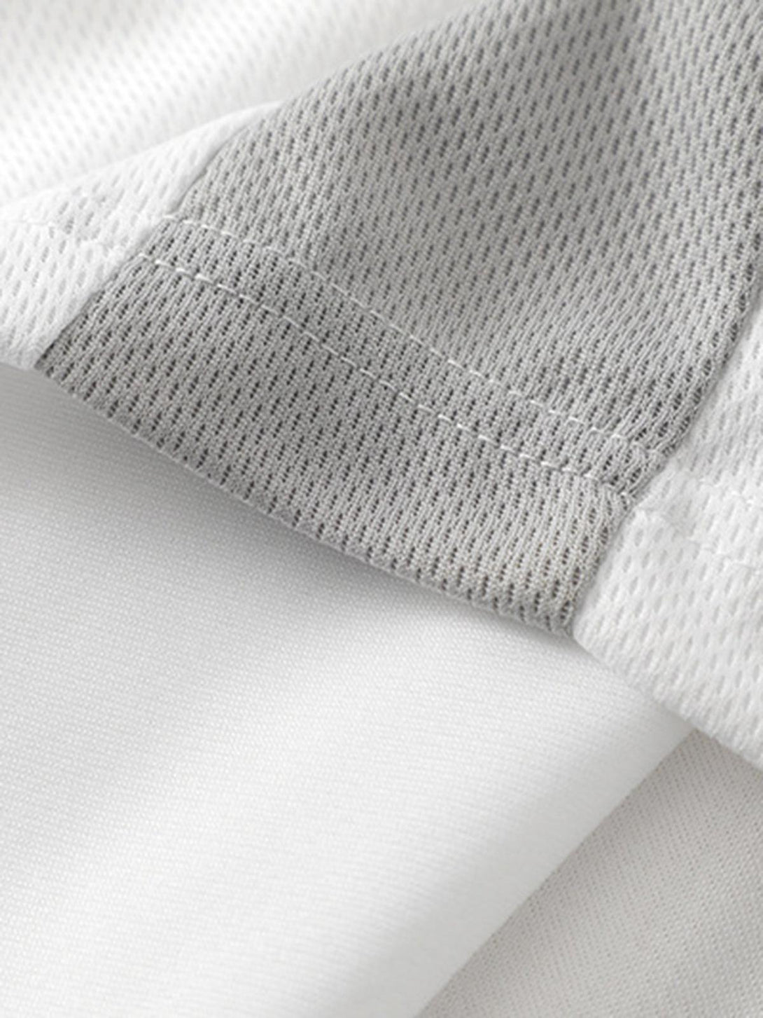 Detailed fabric and stitching on a TALISHKO Gothic font jersey street rap t-shirt.