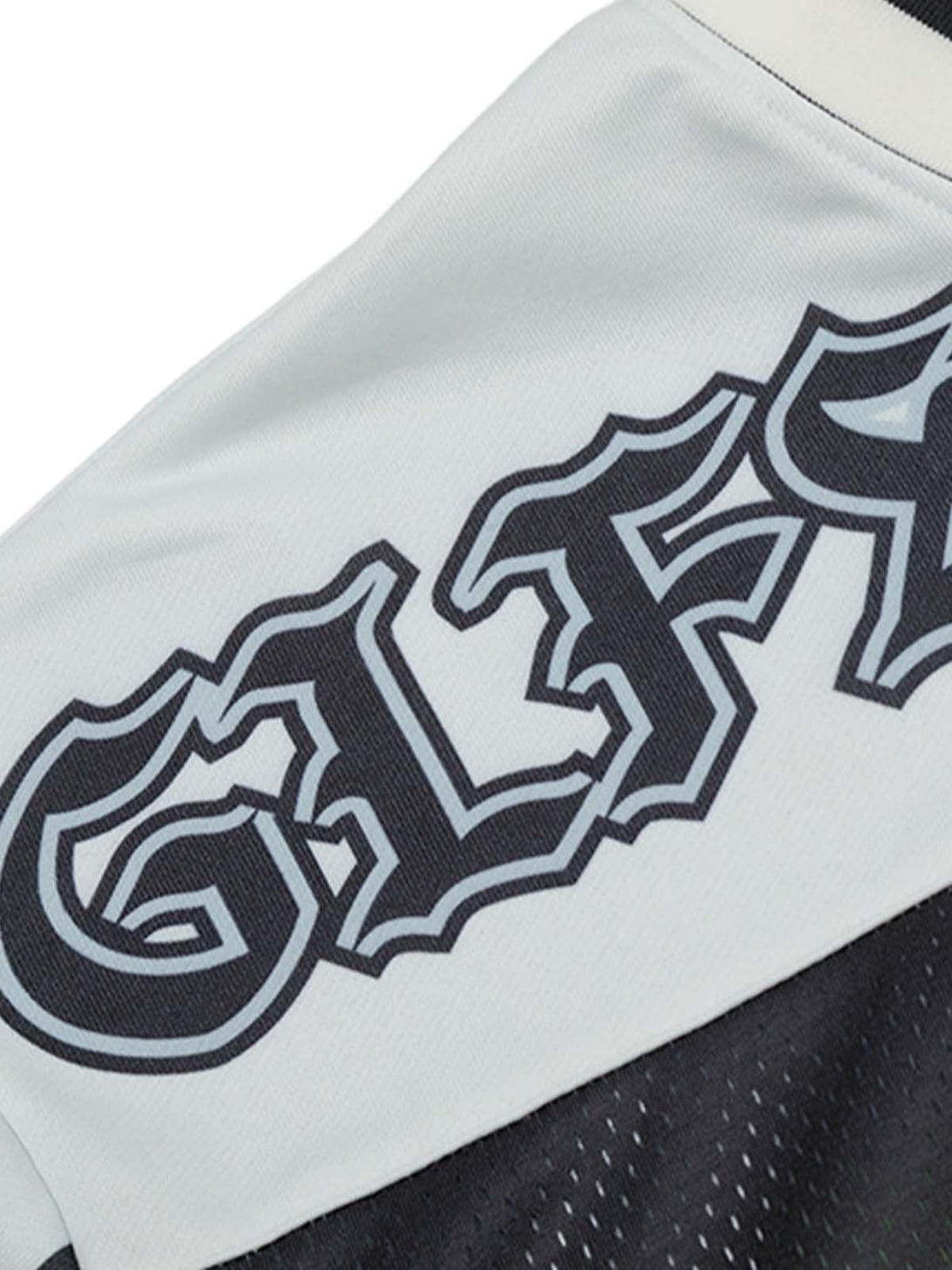 A detailed view of TALISHKO's Gothic-style jersey T-shirt highlighting bold embroidered lettering.