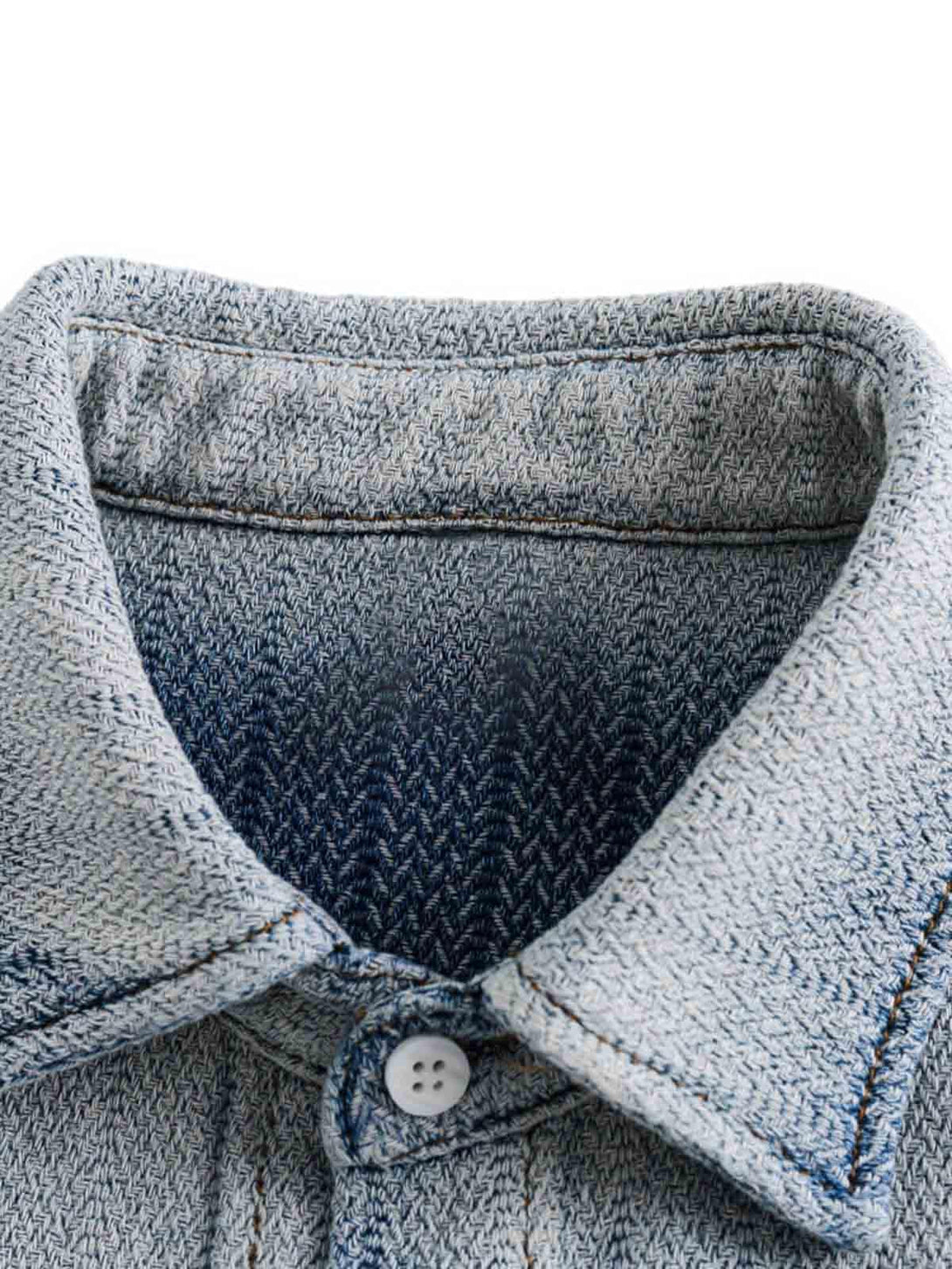 Zoomed-in texture of TALISHKO's gradient denim shirt collar, highlighting intricate stitching.