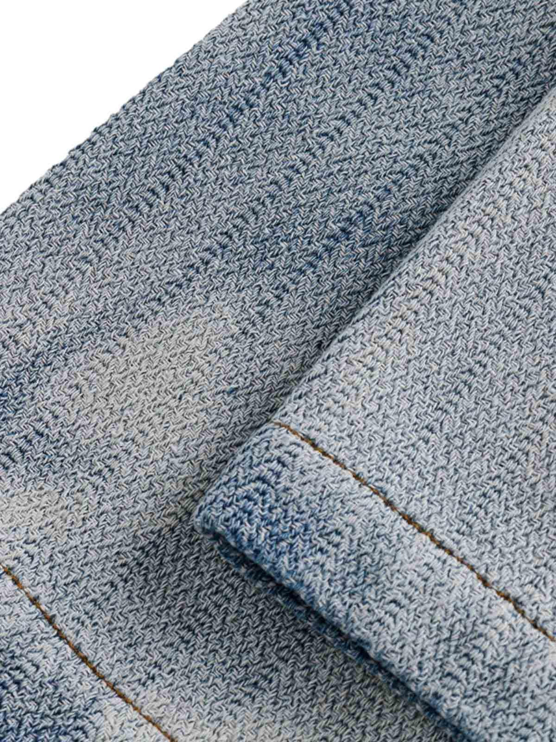 Texture and pattern showcased in TALISHKO's gradient denim shirt, highlighting sleeve detail.