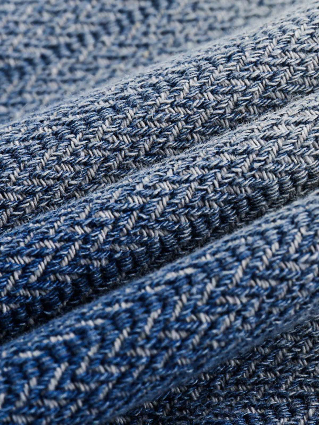 Intricate look at TALISHKO's gradient denim fabric, highlighting rich texture and weave.