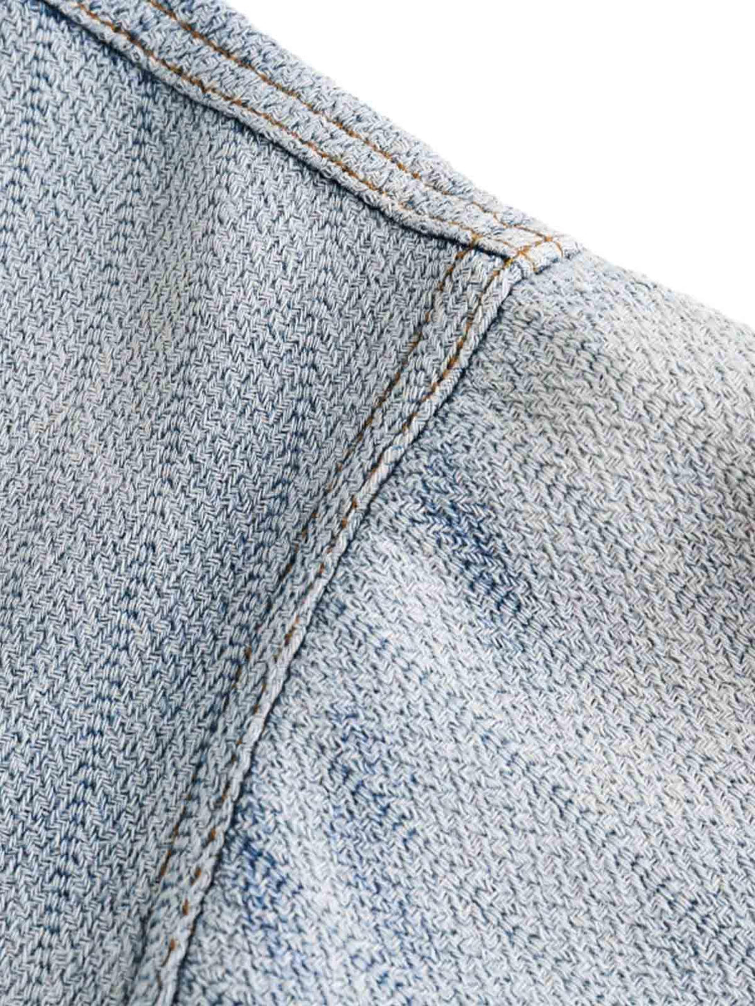 Intricate look at TALISHKO's gradient denim shirt sleeve, emphasizing detailed stitching.