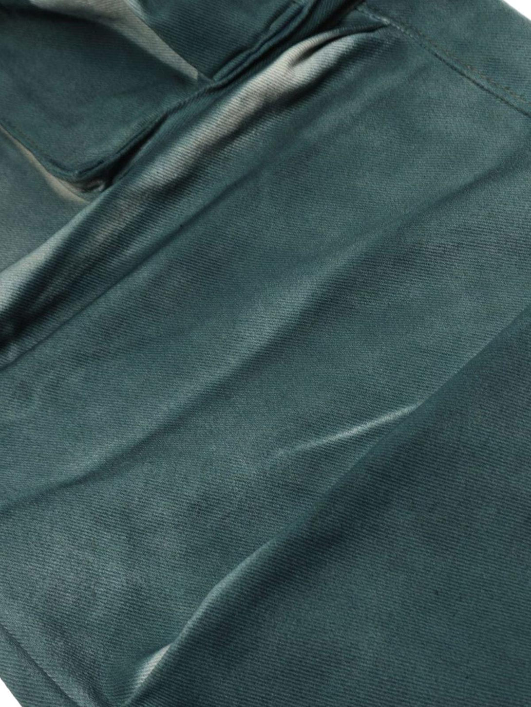 A detailed view of TALISHKO's gradient dip dye cargo jeans, highlighting multi-pocket design.