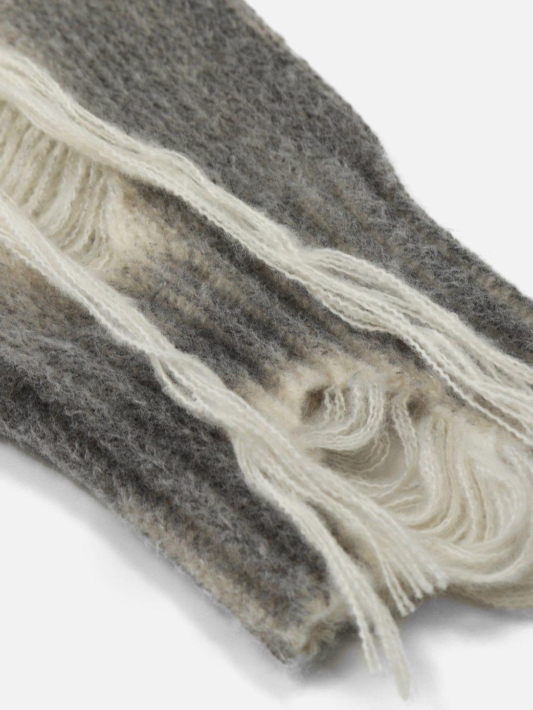 A close-up of TALISHKO's gradient distressed polo sweater, highlighting its soft texture.