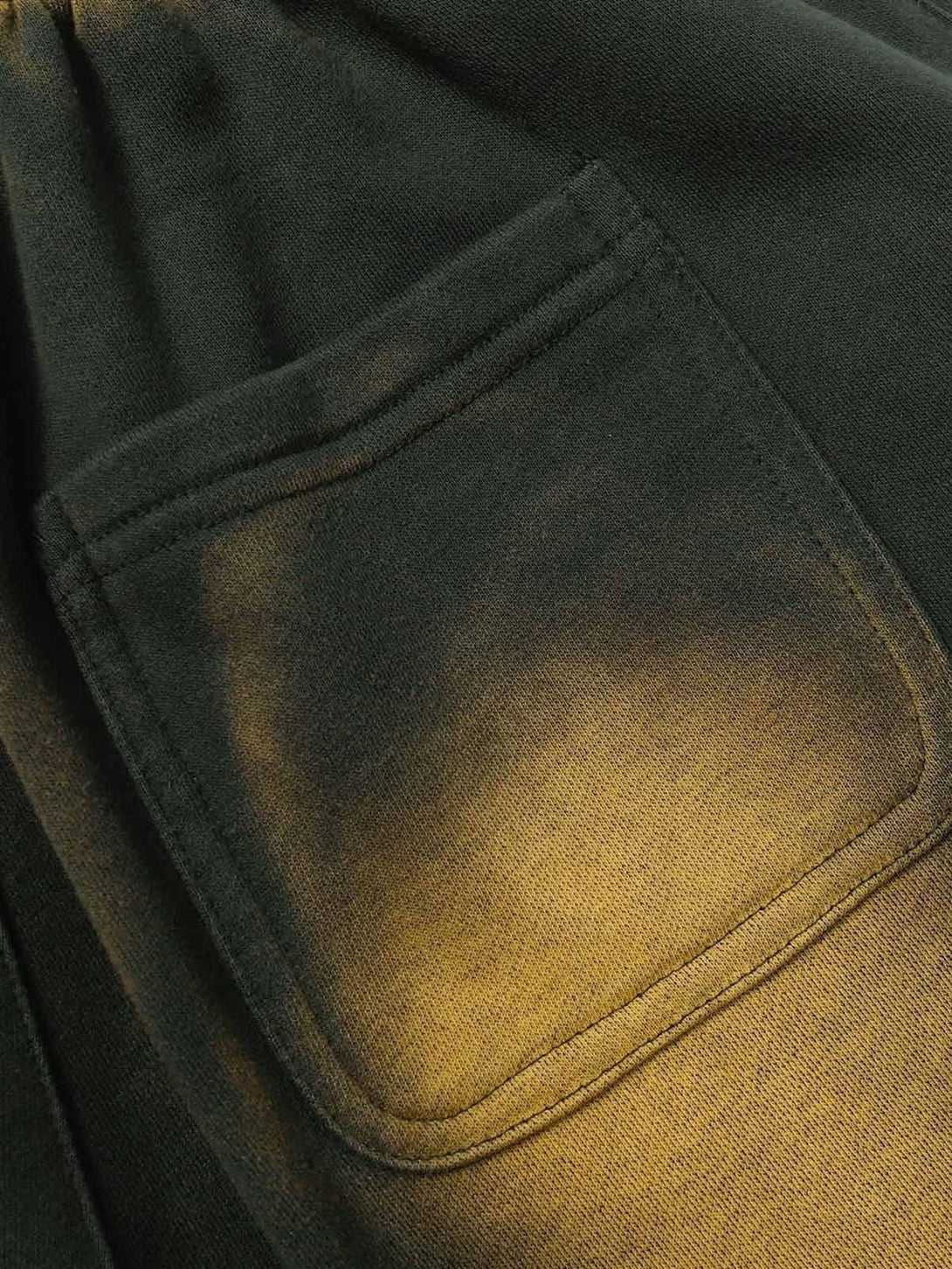 A detailed view of TALISHKO drawstring shorts pocket, showcasing the gradient fabric texture.