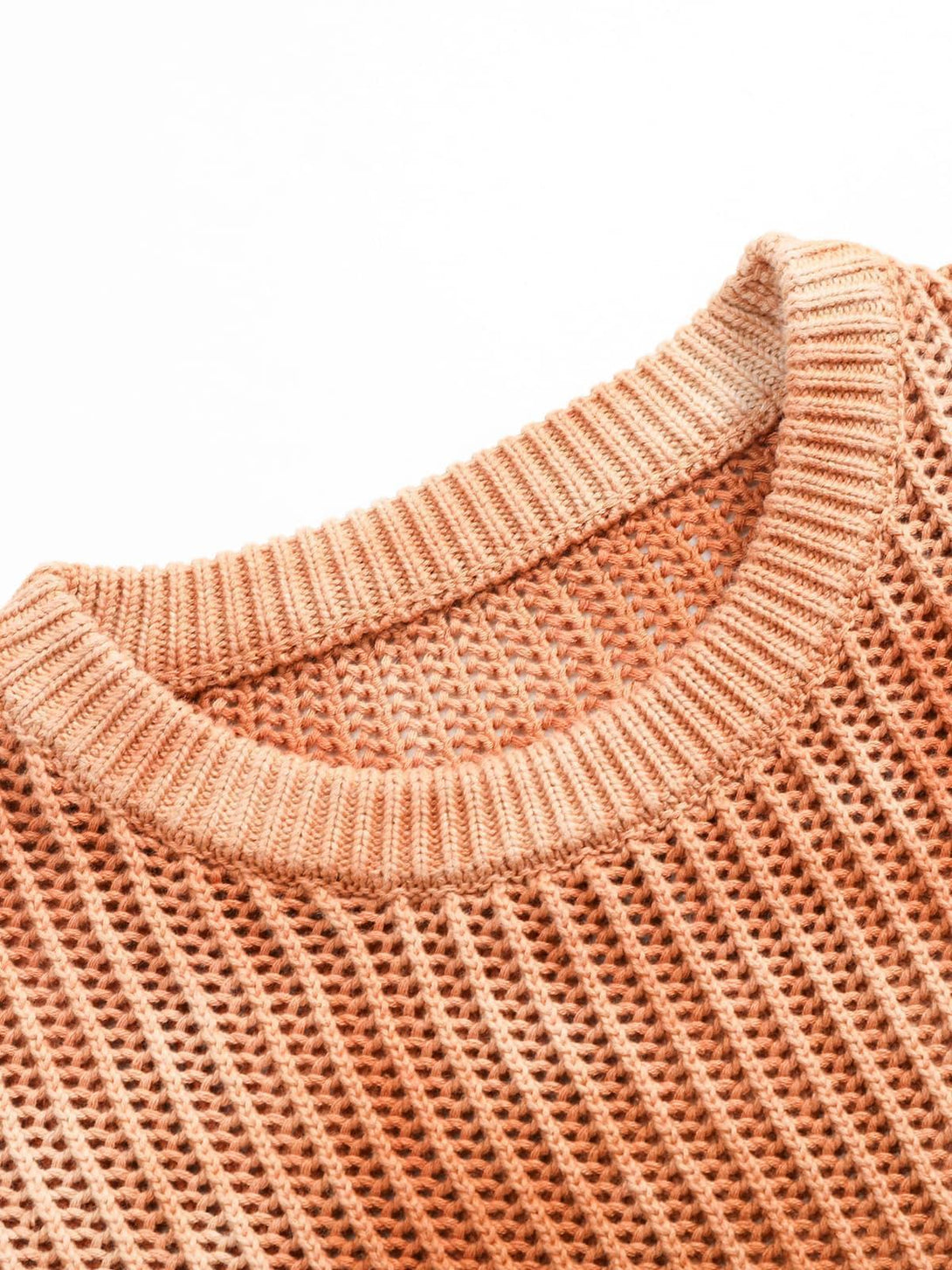 A detailed view of TALISHKO's gradient ombre knit sweater, highlighting the textured crew neck.
