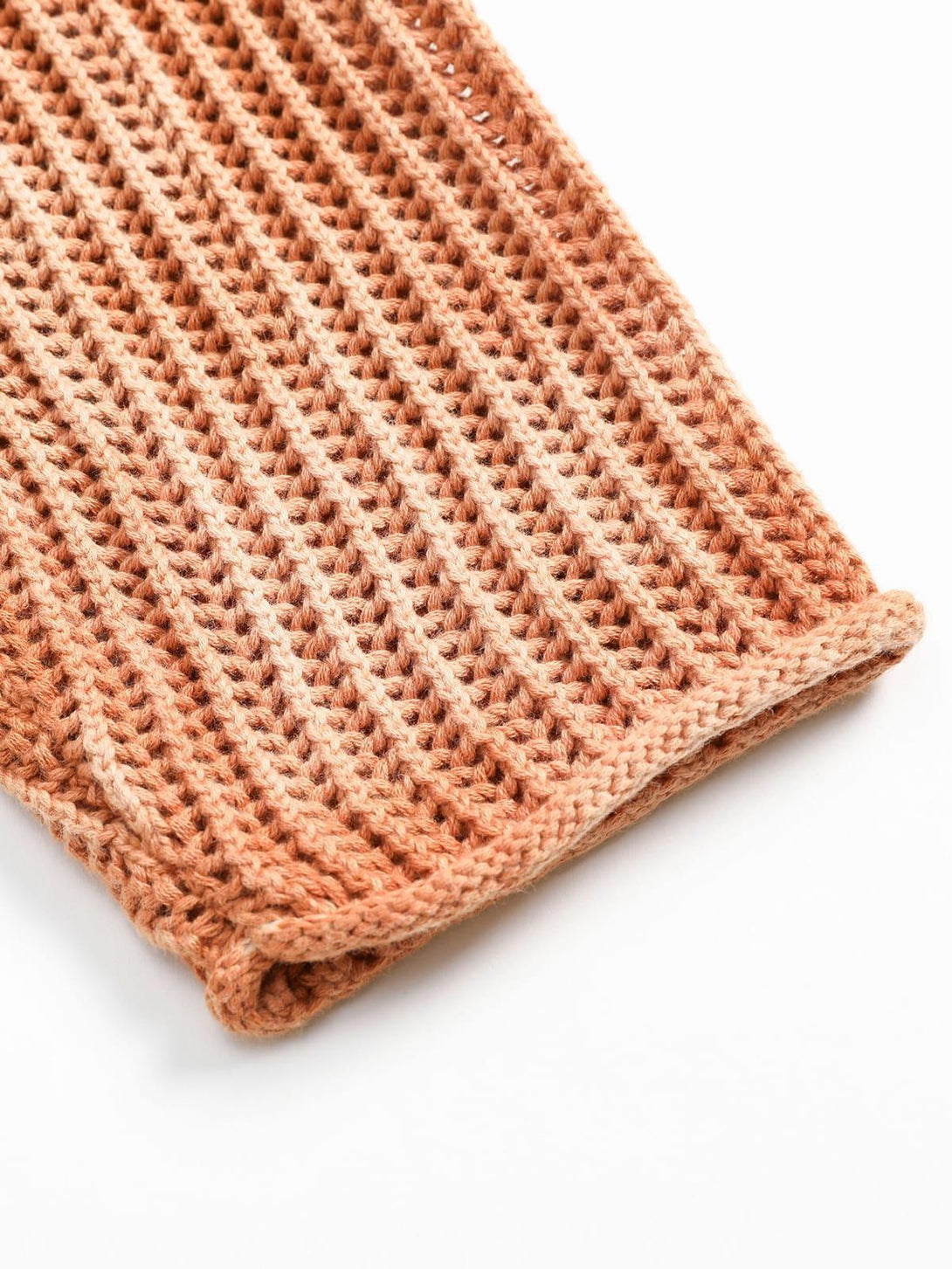 Texture and pattern showcased on TALISHKO's gradient ombre knit sweater, highlighting rich detail.