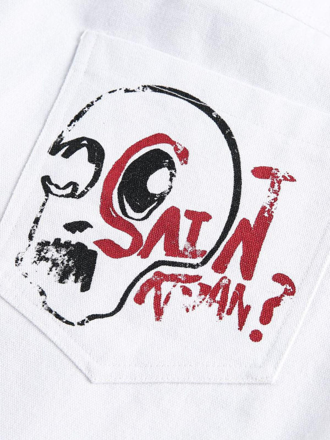 Zoomed-in design detail on TALISHKO denim shorts pocket featuring bold graffiti art.