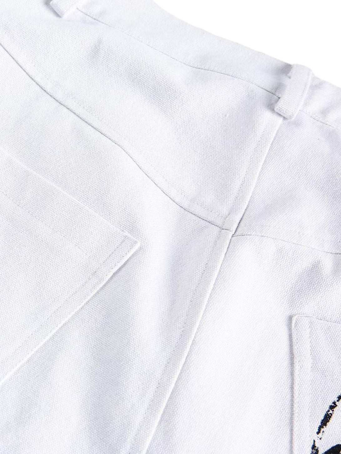 A detailed view of TALISHKO denim shorts highlighting white fabric and unique stitching details.