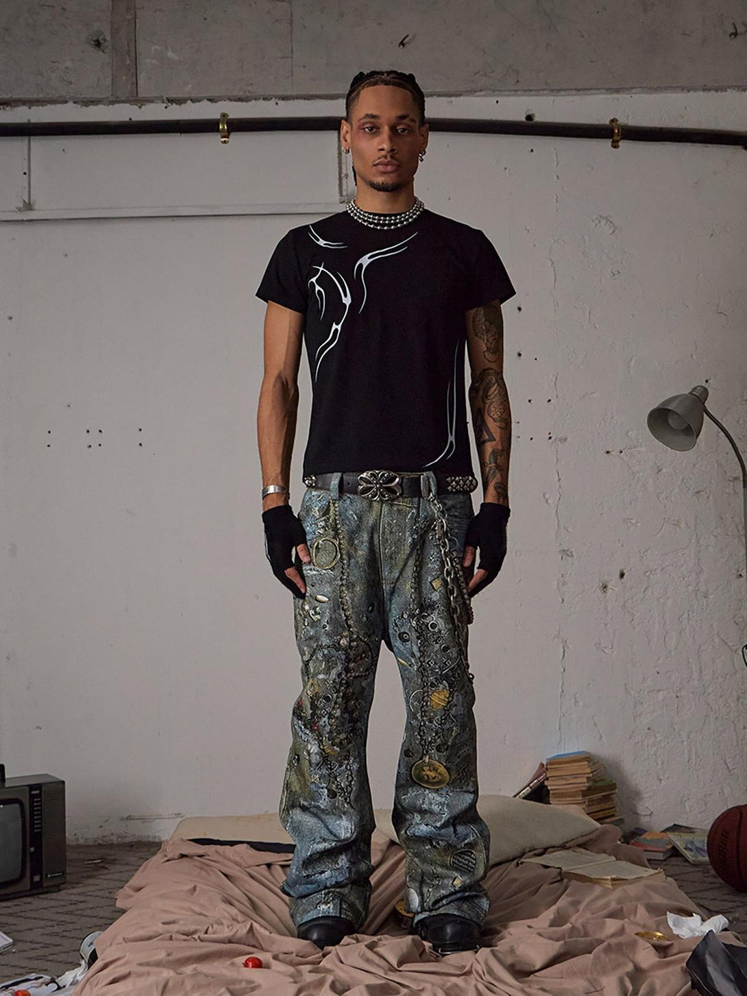 Model wearing TALISHKO Graffiti BORO Destruction Chain Jeans with a stylish black tee.