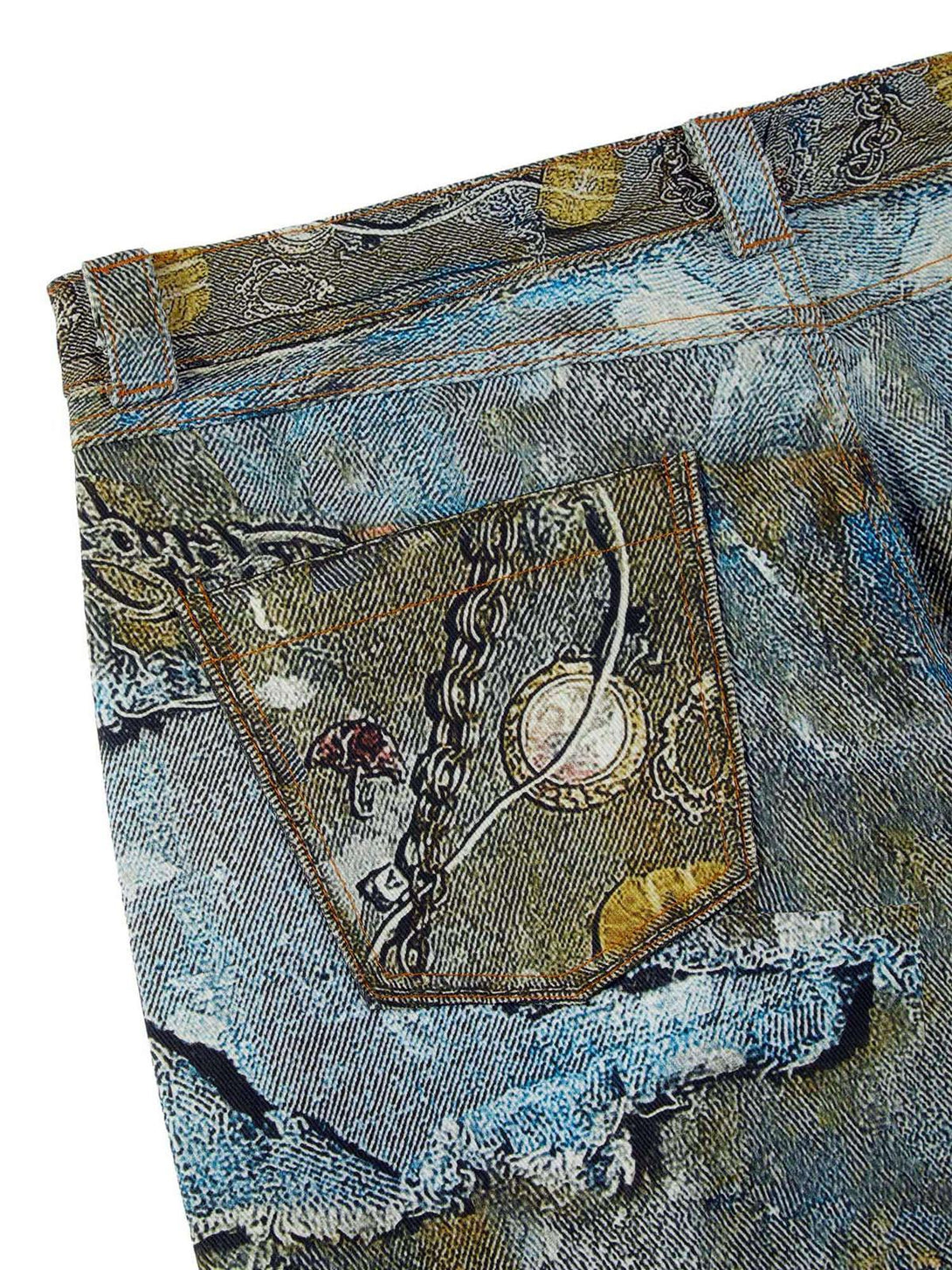 Detailed view of TALISHKO jeans highlighting graffiti patterns and chain embellishments.