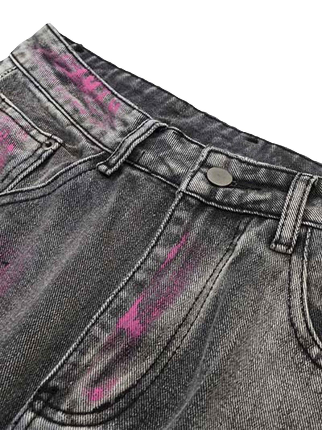 A close-up of TALISHKO's graffiti distressed jeans highlighting pink accents and detailed stitching.