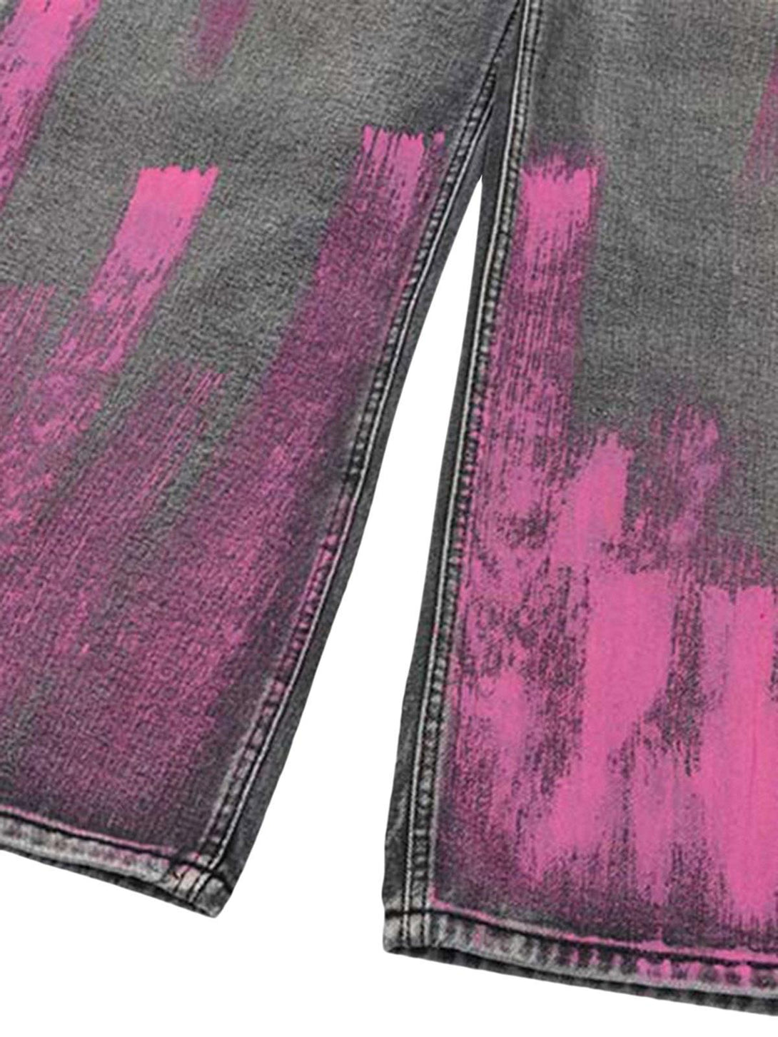 A close-up of TALISHKO's baggy jeans showcasing pink graffiti brushstrokes and distressed texture.