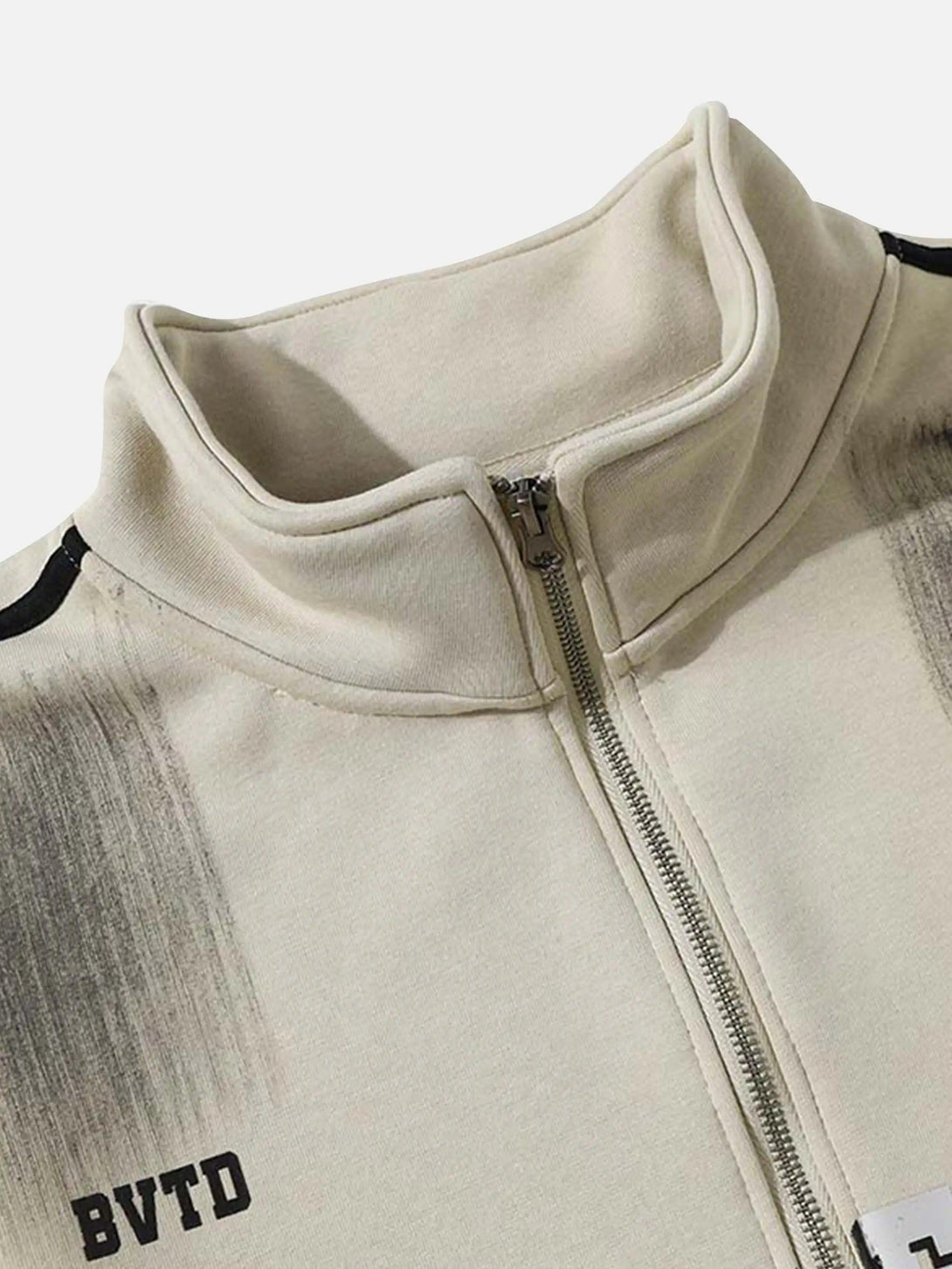 A detailed view of TALISHKO's jacket collar and zipper, highlighting the graffiti-inspired design.