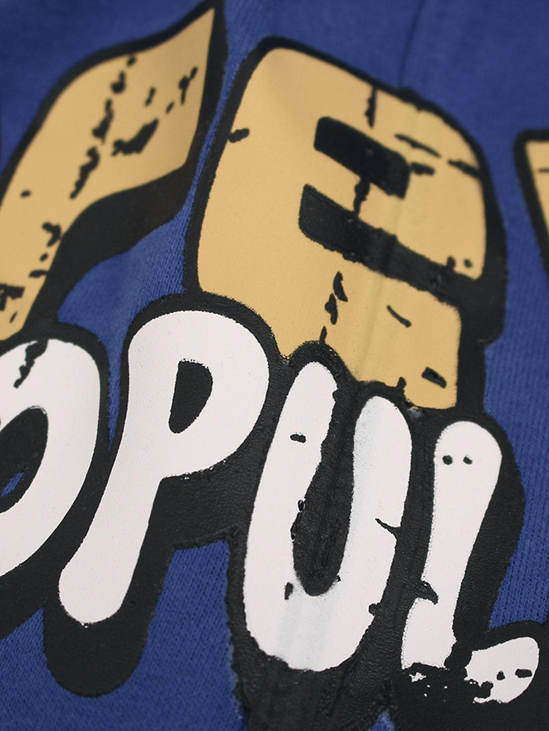 A tight crop highlighting the graffiti design on TALISHKO's cotton shorts, showcasing bold lettering.