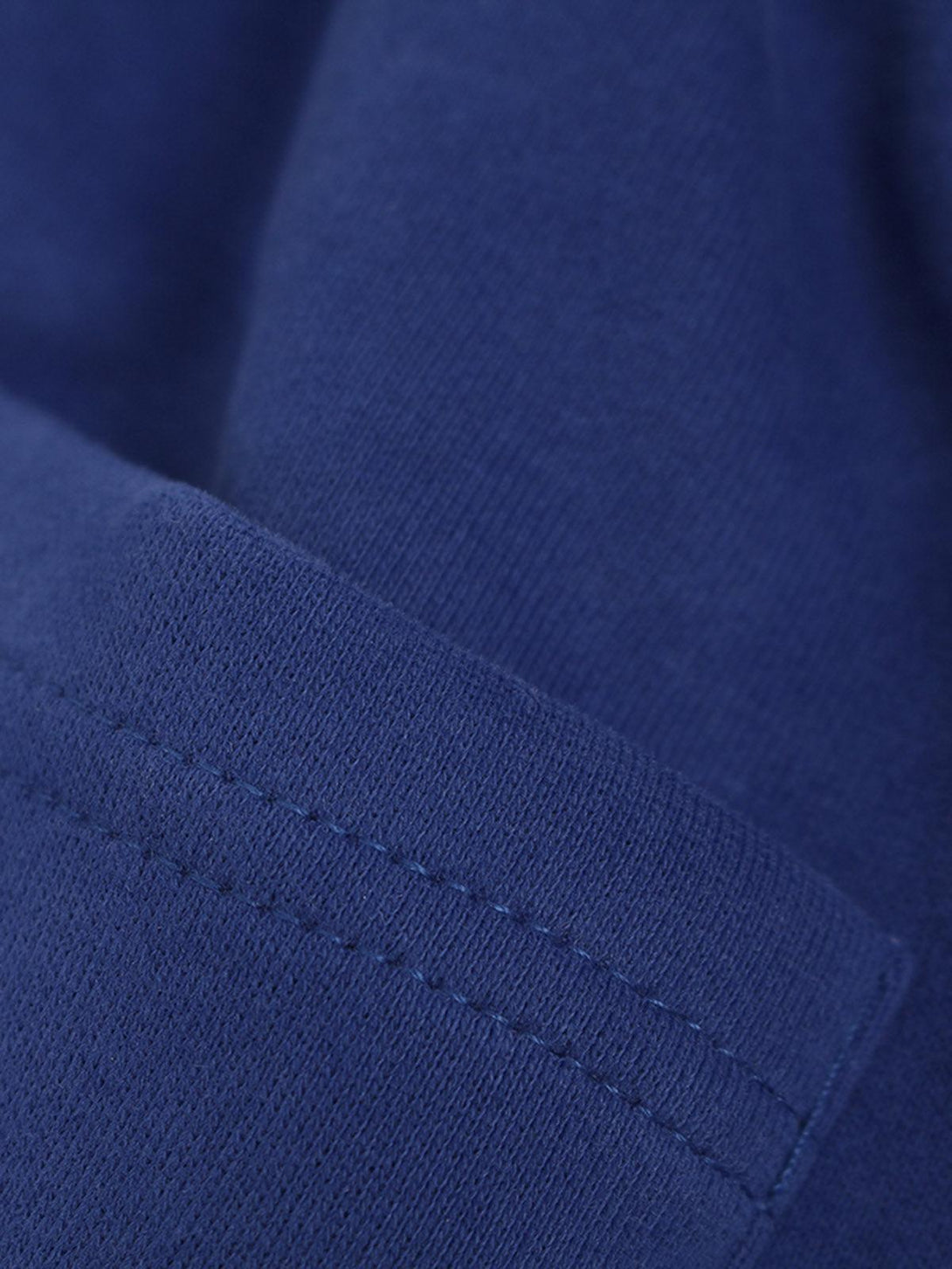 Detailed fabric and stitching of TALISHKO blue cotton shorts, showcasing craftsmanship.