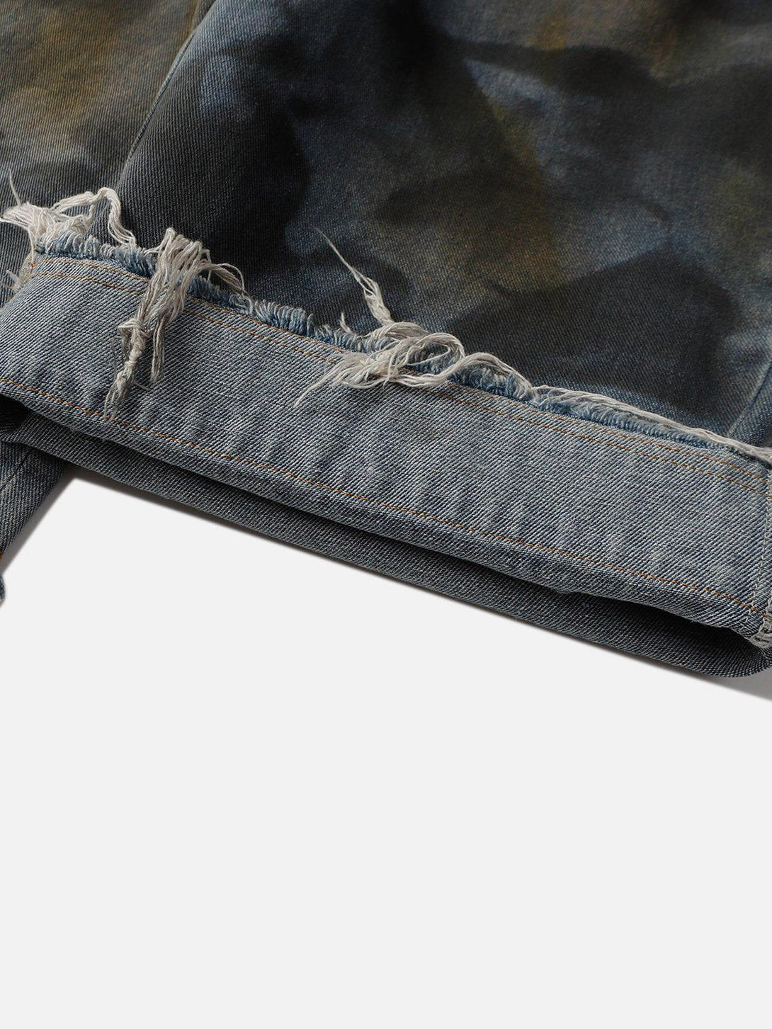 Frayed hem detail of graffiti fringe jorts by TALISHKO, emphasizing edgy summer style.