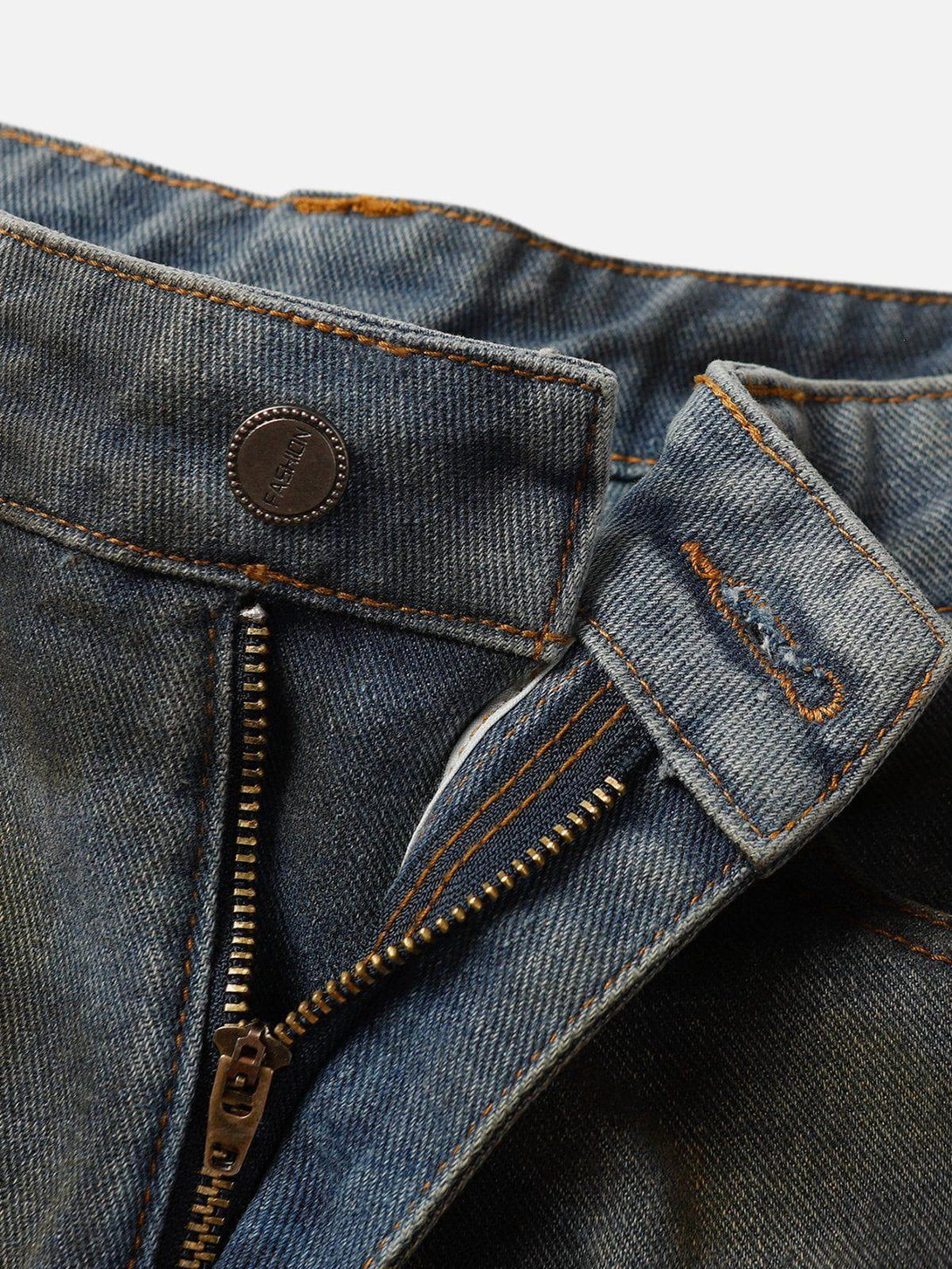 A detailed look at TALISHKO's graffiti fringe jorts, highlighting rugged zipper and stitching.