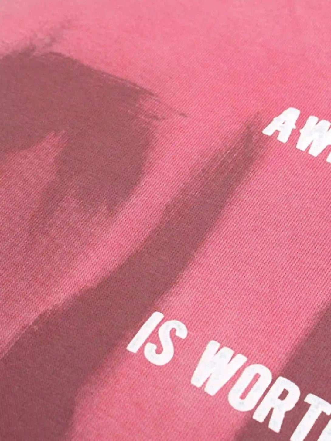 Intricate look at the pink fabric of a TALISHKO hoodie, featuring bold white lettering.