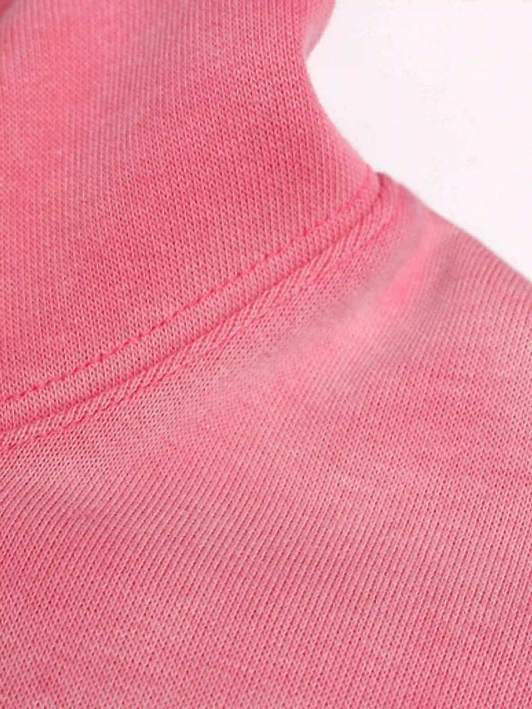 Zoomed-in texture of a pink hoodie by TALISHKO, highlighting intricate fabric and stitching.