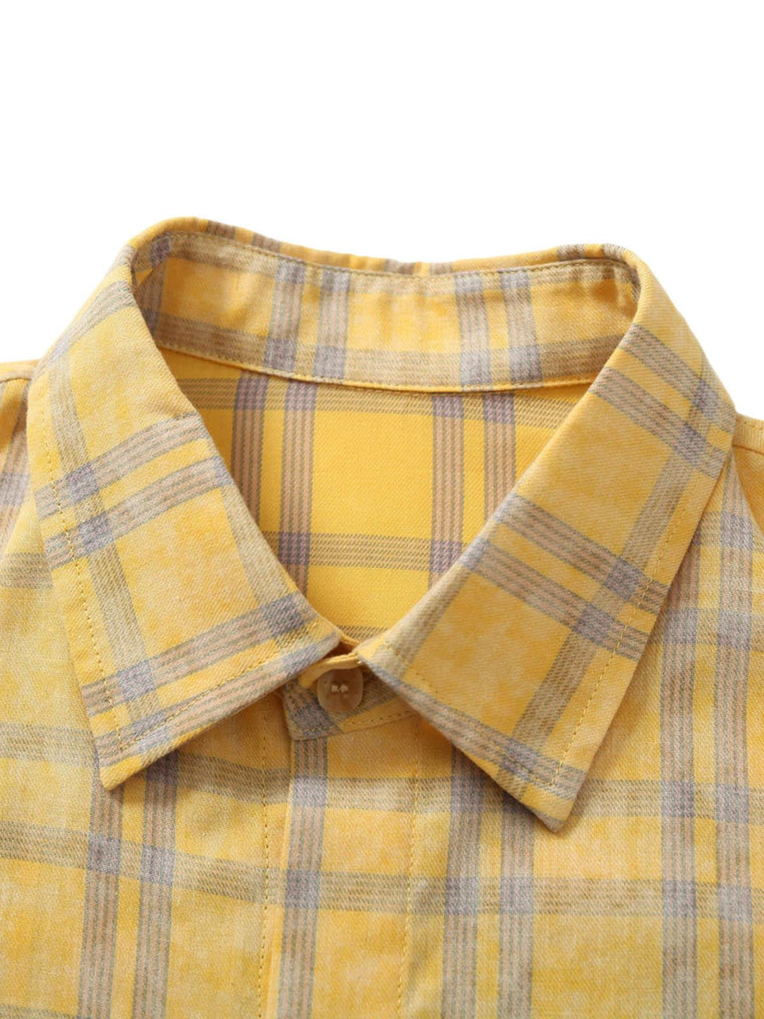 A close-up of a yellow plaid polo shirt collar by TALISHKO, highlighting its stylish design.