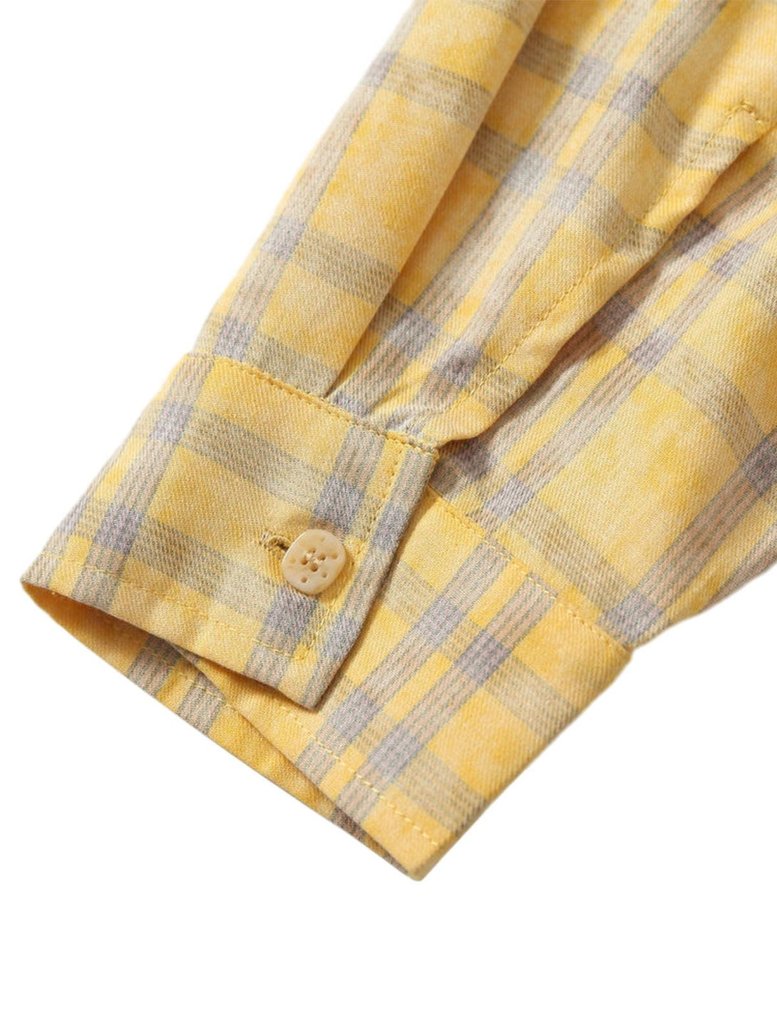 A tight crop highlighting the cuff detail of TALISHKO's yellow plaid polo shirt.