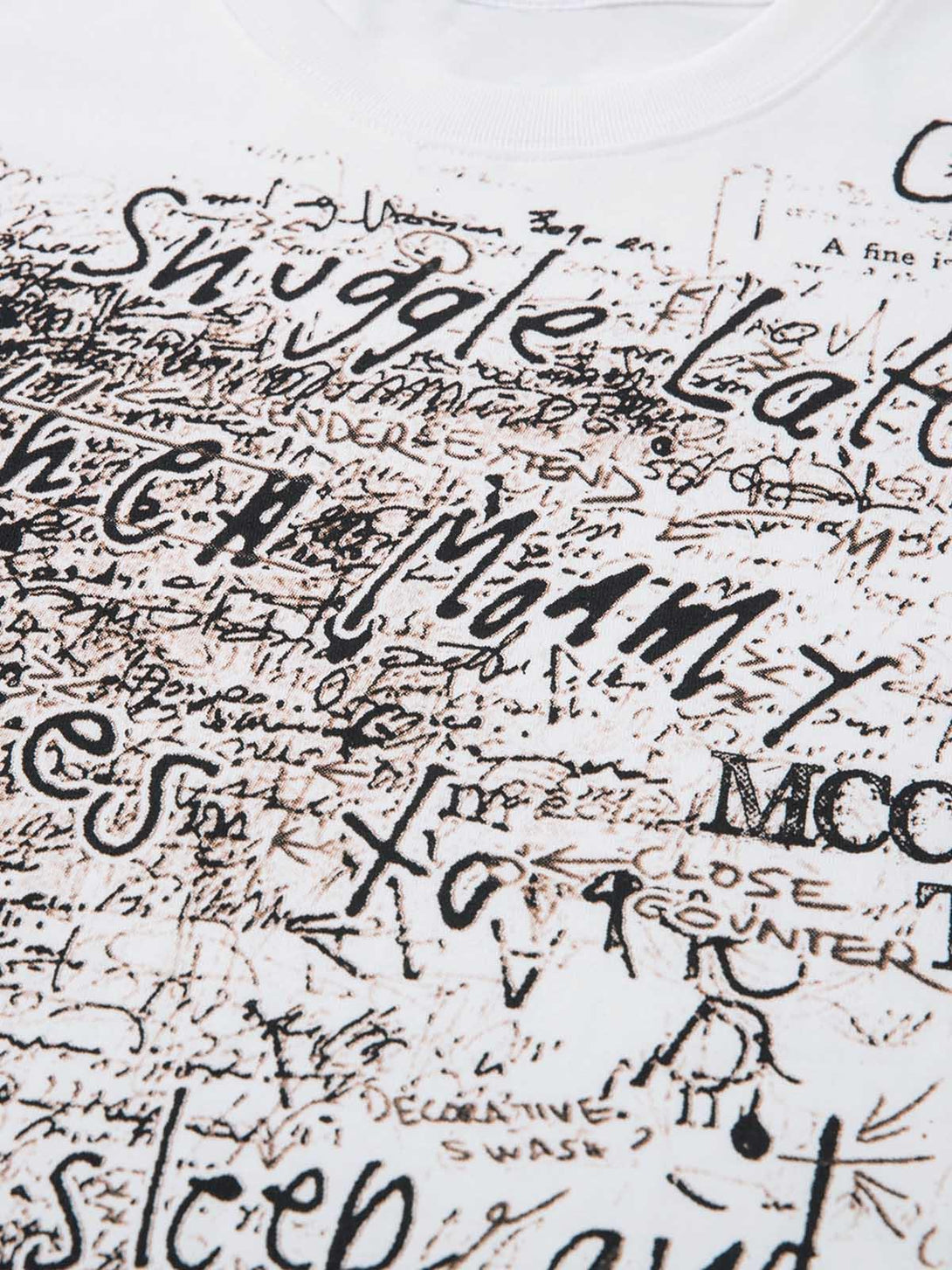 Intricate look at the graffiti letter design on TALISHKO's oversized T-shirt fabric.