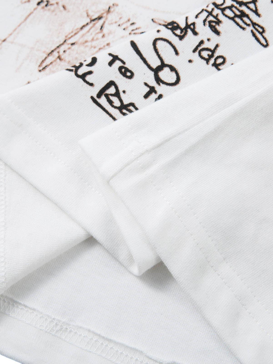 Intricate look at the graffiti print details on TALISHKO's oversized T-shirt fabric.