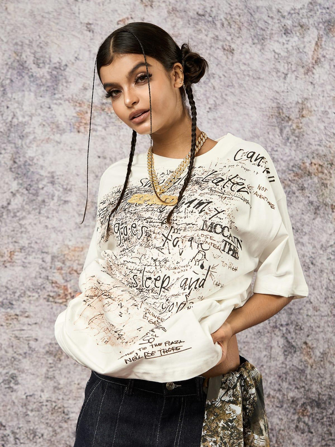 Model in graffiti letter print oversized T-shirt by TALISHKO, paired with stylish denim.