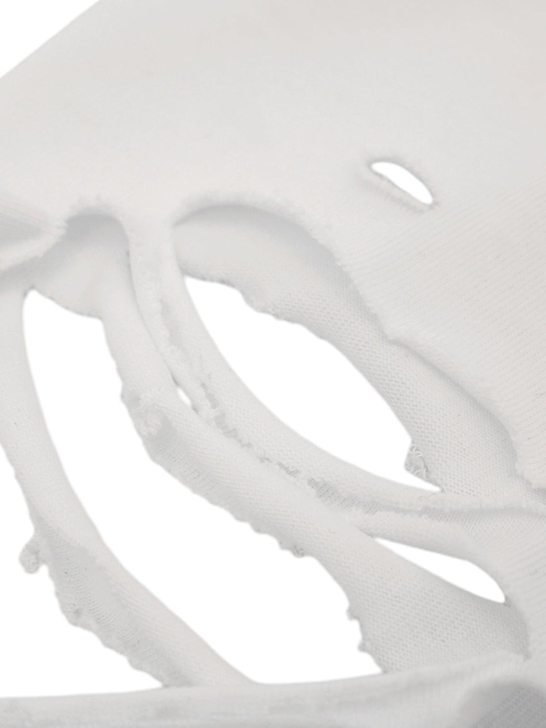 Intricate look at the distressed fabric detail on a TALISHKO graphic T-shirt.