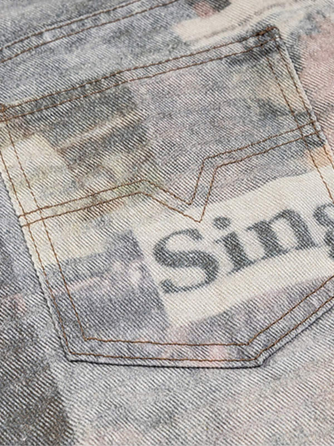 A detailed view of TALISHKO's graffiti-inspired jeans pocket, highlighting unique newspaper print.