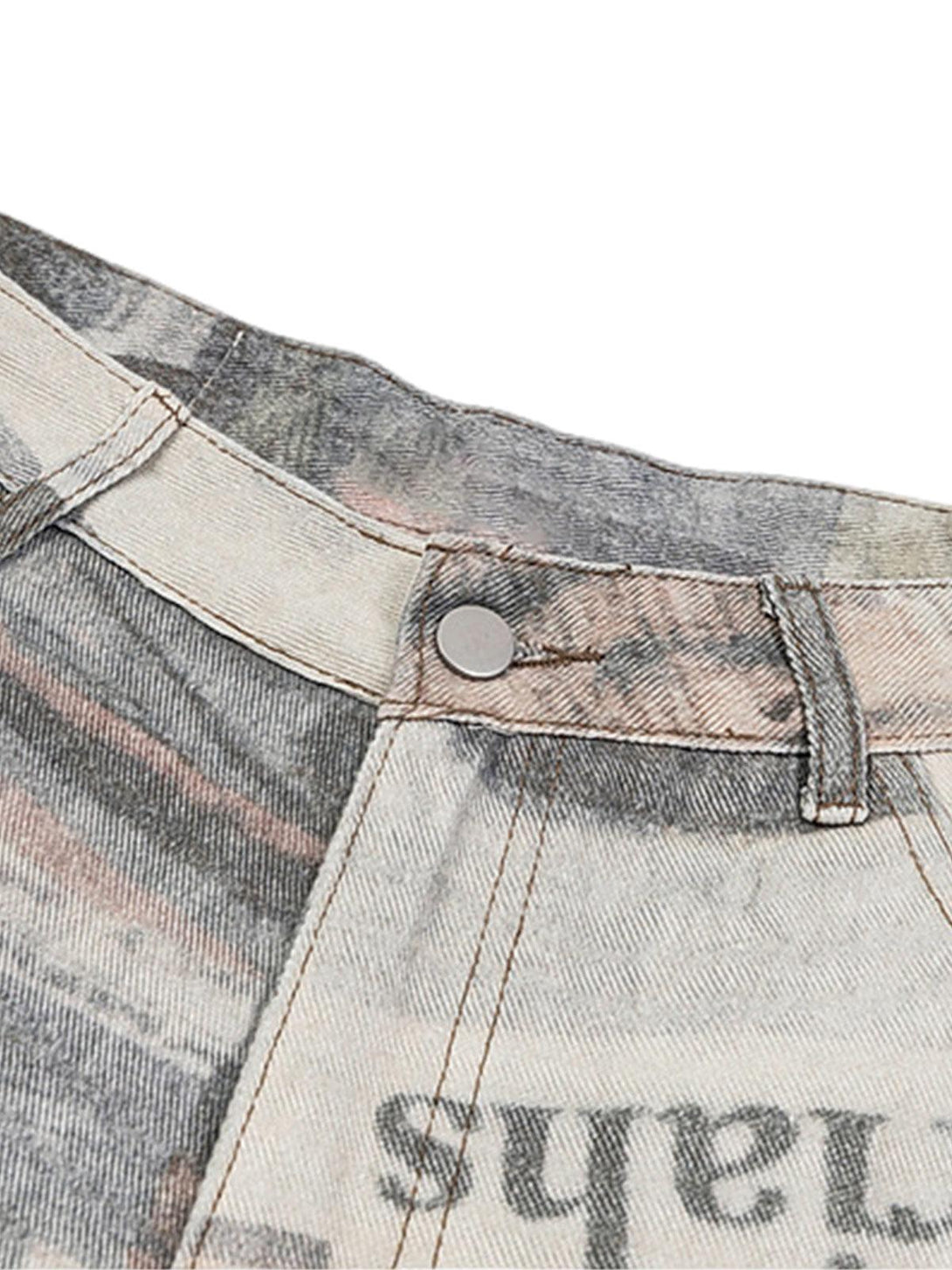 Intricate look at TALISHKO's graffiti newspaper jeans, highlighting unique button detail.