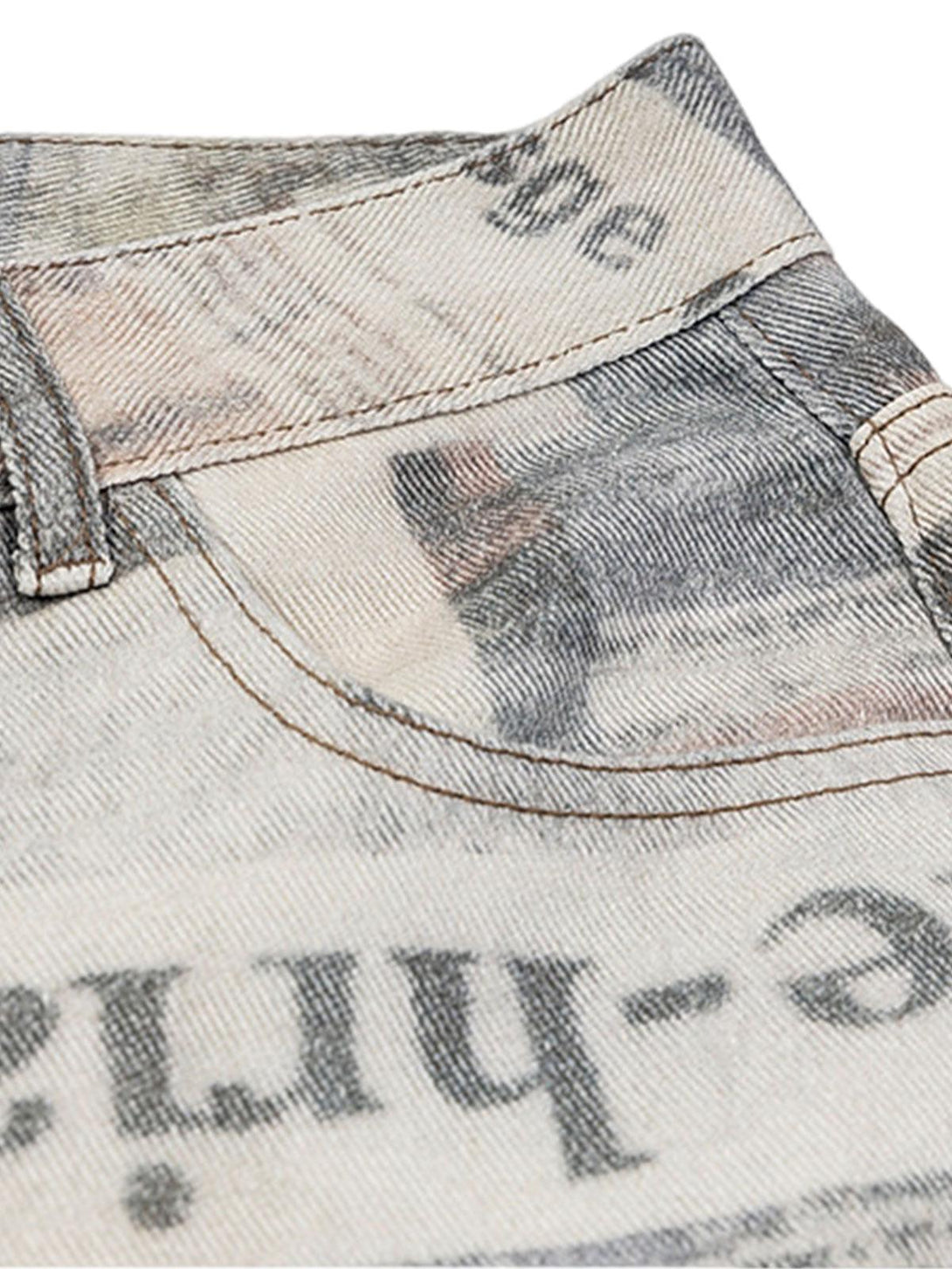 A close-up of TALISHKO's graffiti-inspired jeans, highlighting the unique newspaper print design.