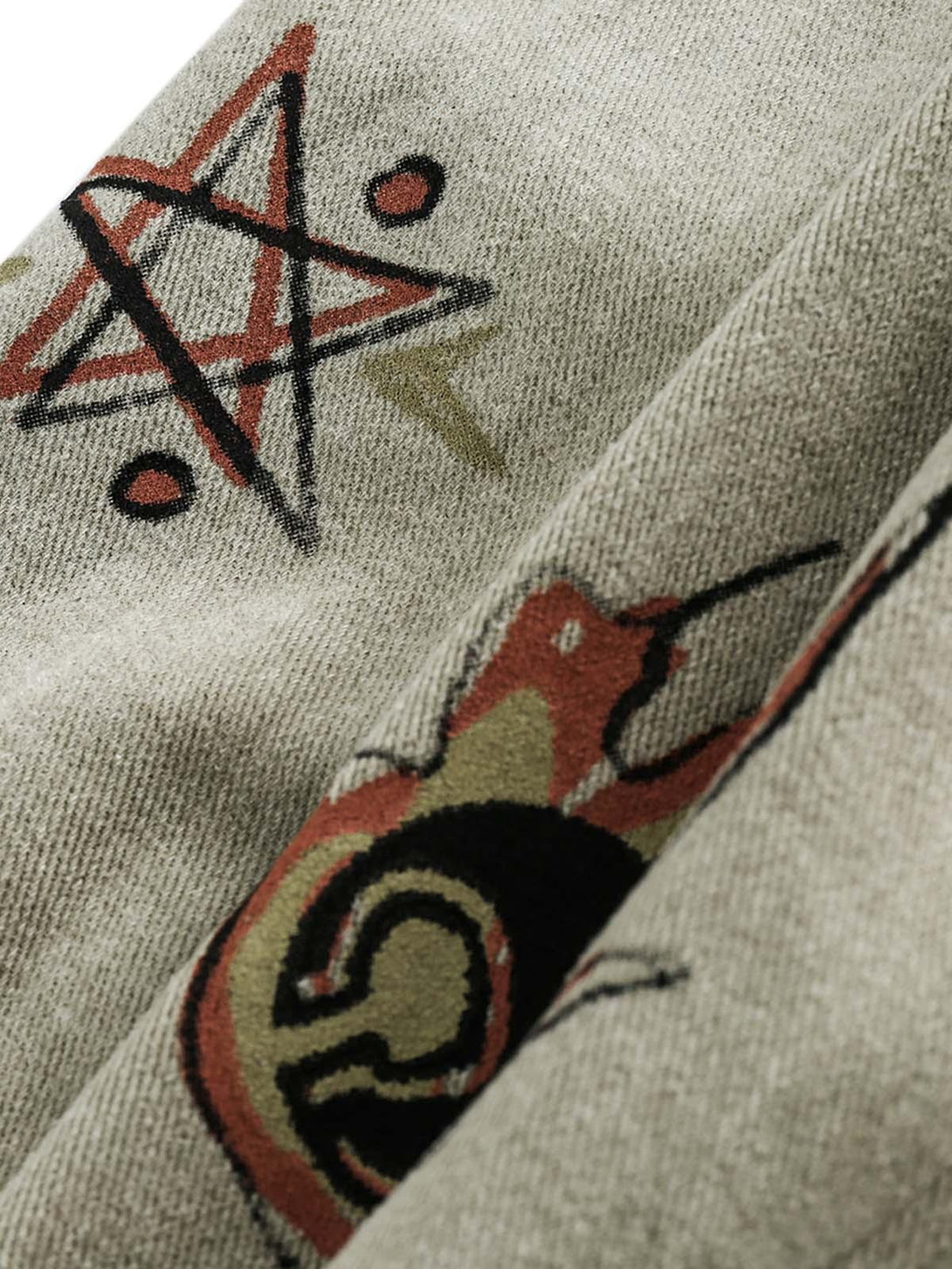 A tight crop highlighting the graffiti patterns on the denim jacket by TALISHKO.